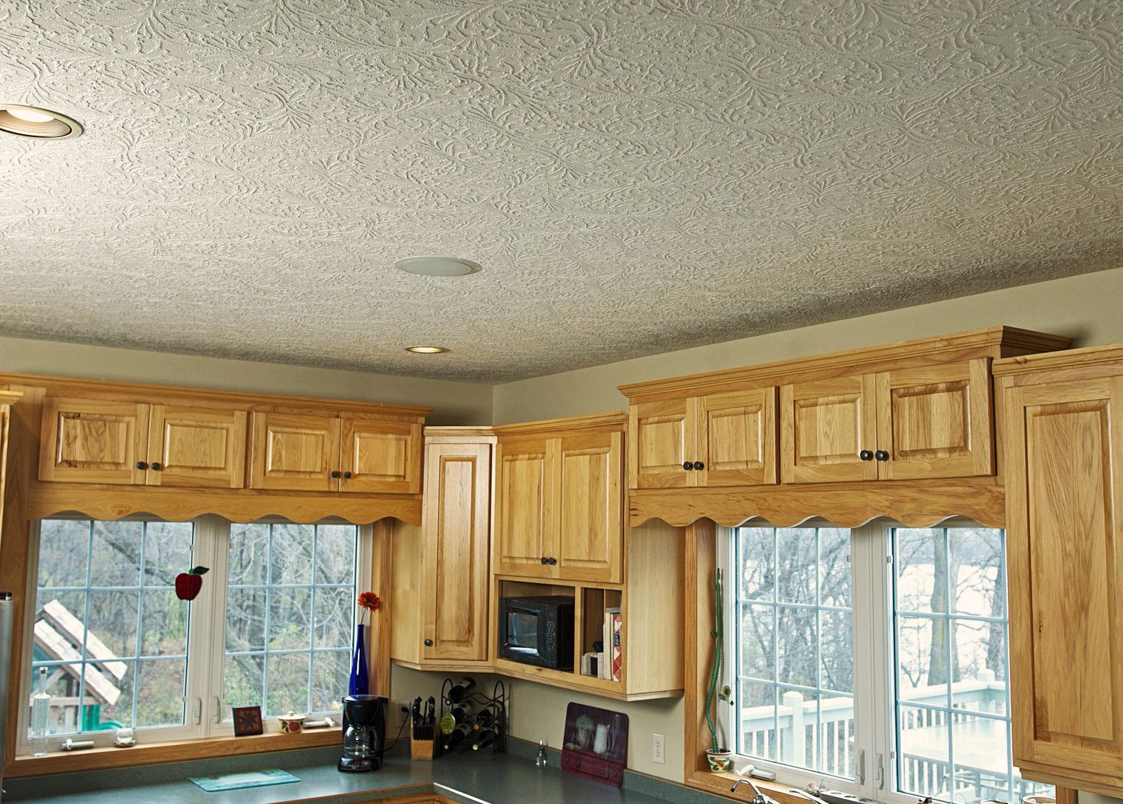 a kitchen with wooden cabinets and a white ceiling