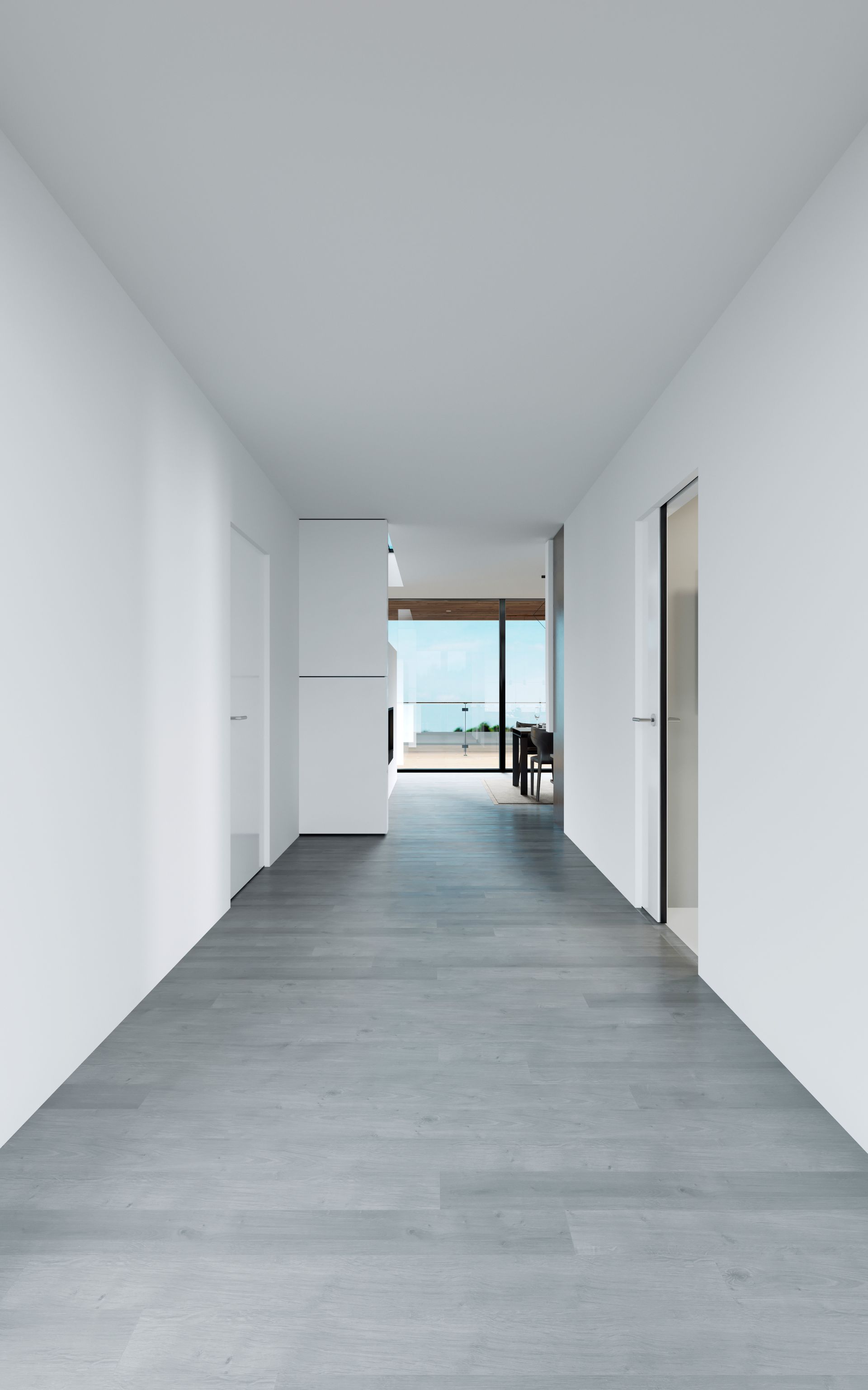 an empty hallway with a wooden floor and white walls in a house .