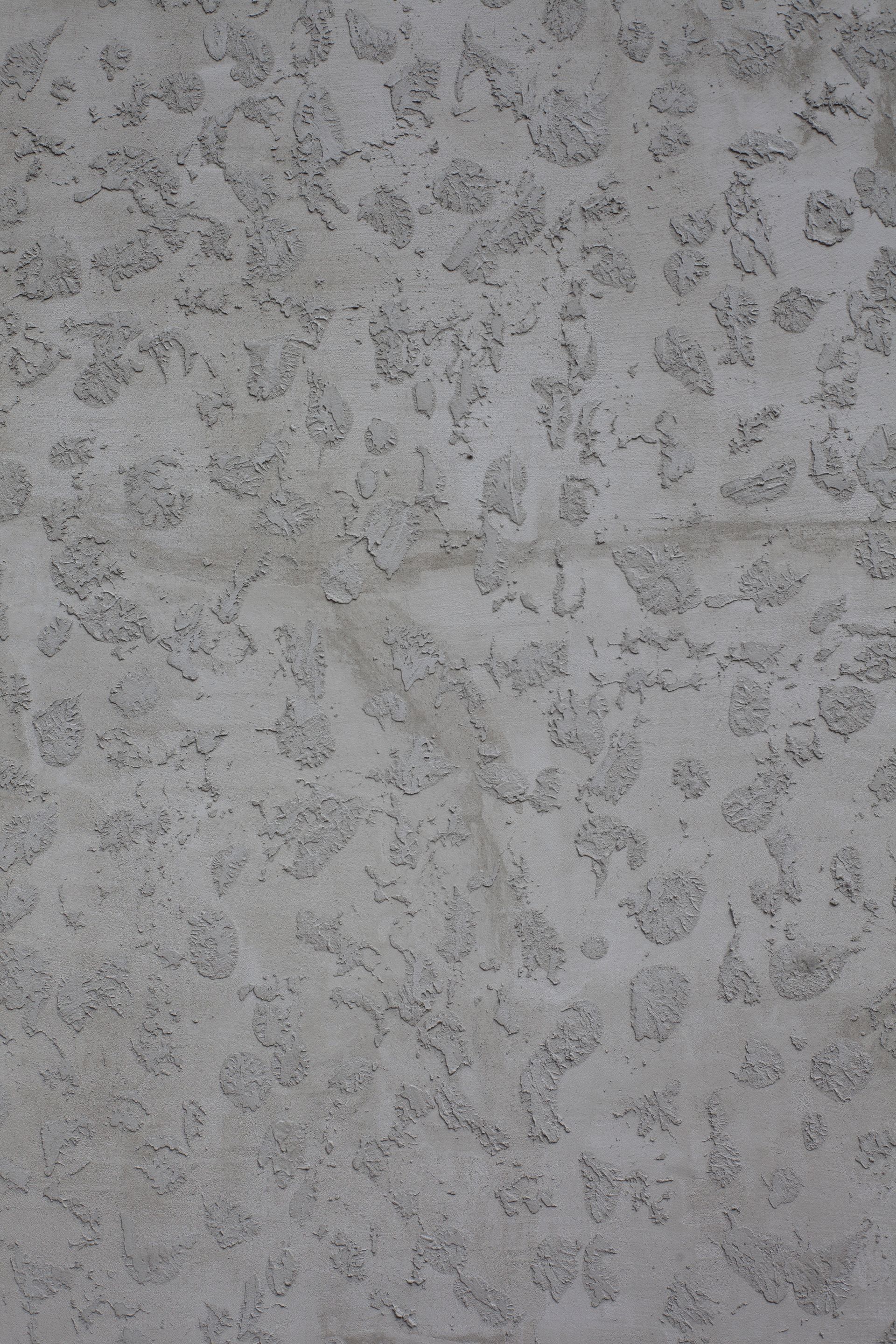a close up of a concrete wall with a pattern on it .