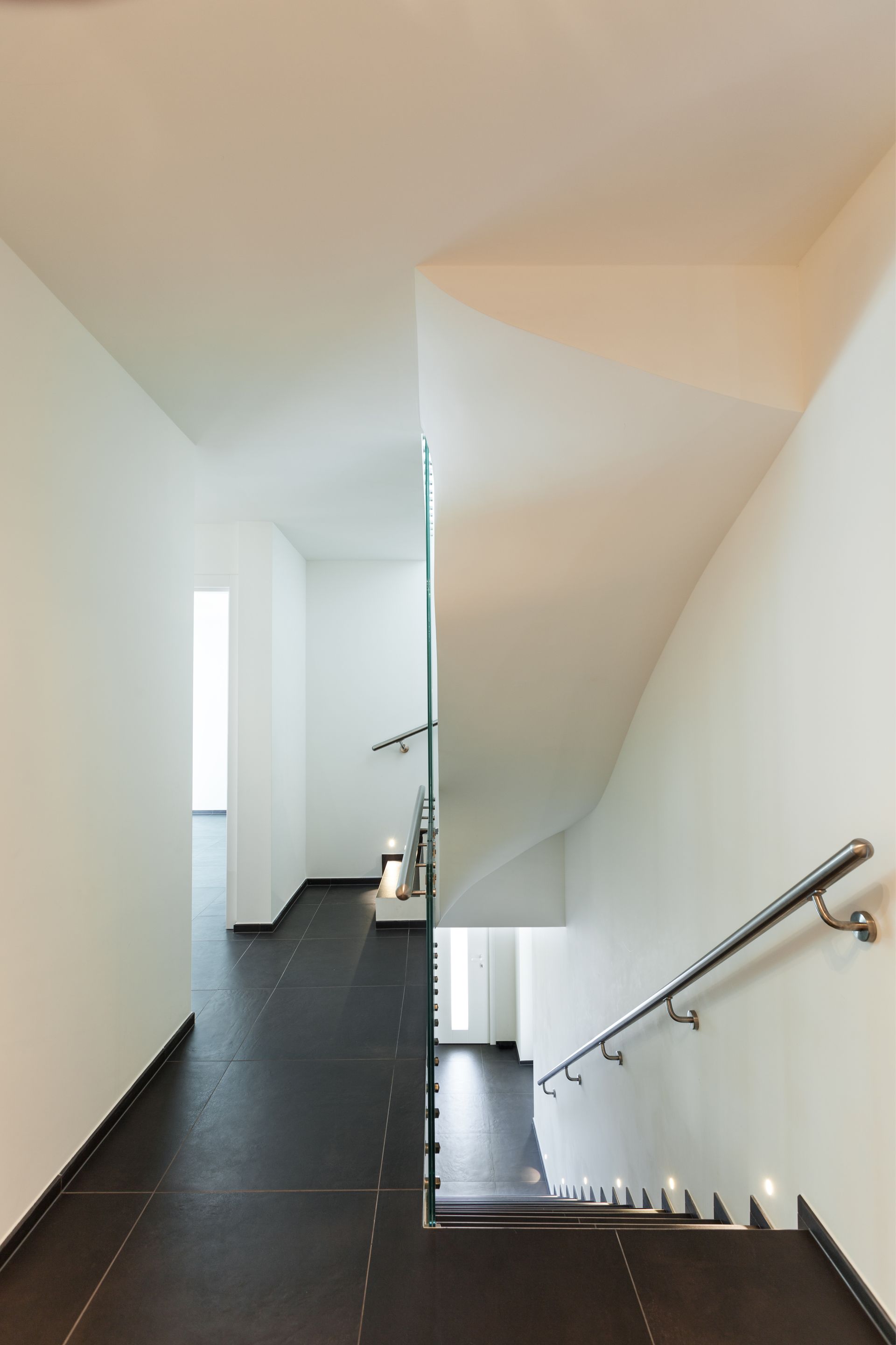 a hallway with stairs leading up to the second floor of a building .