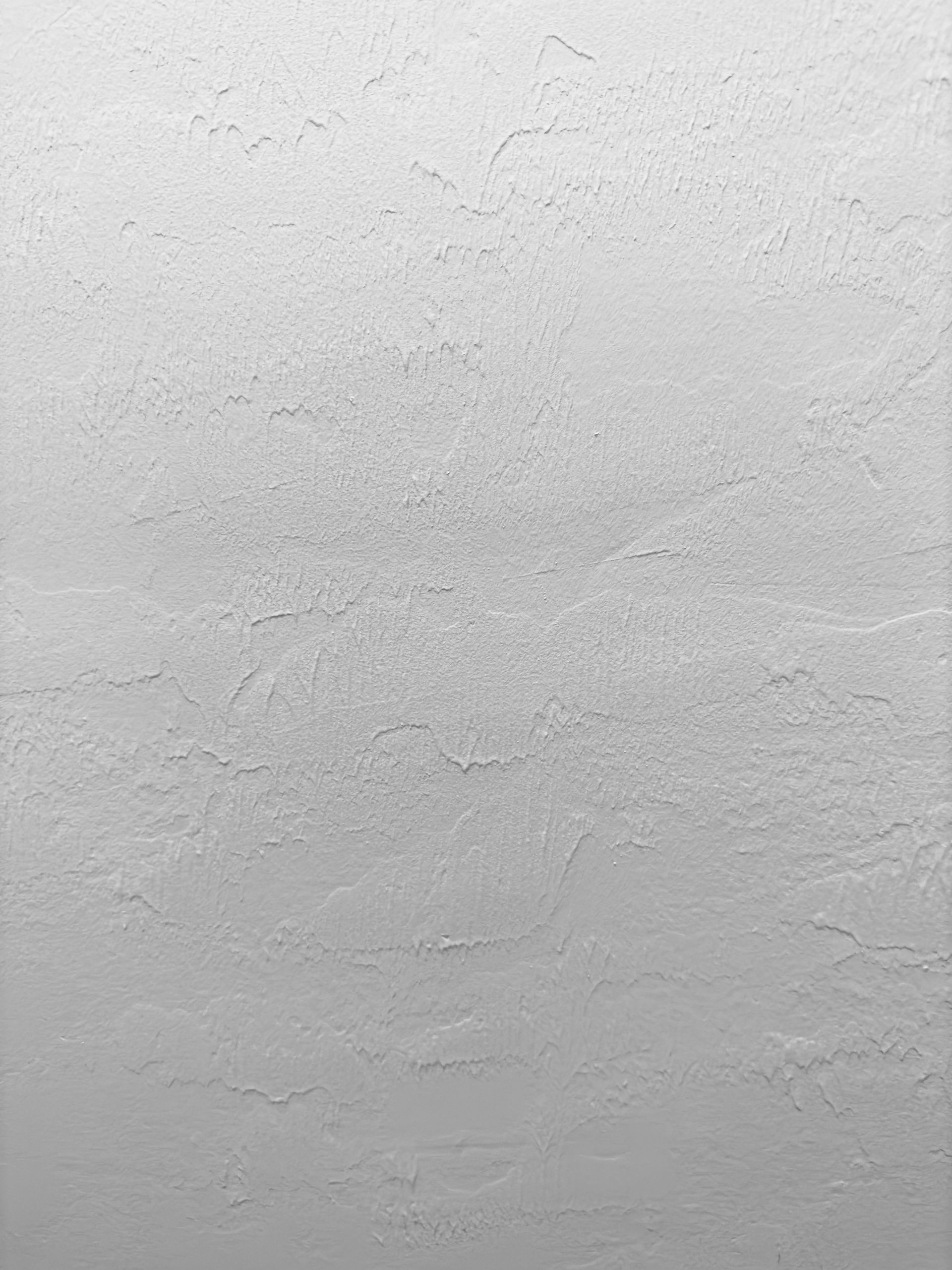 a close up of a white wall with a gray texture .