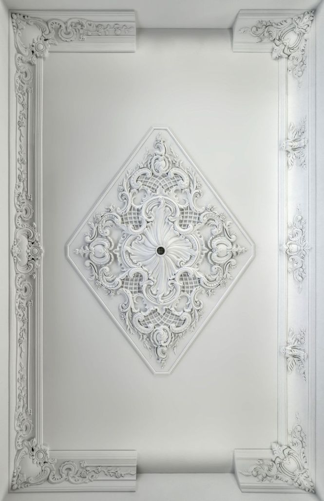 a white ceiling with a diamond shaped decoration on it .