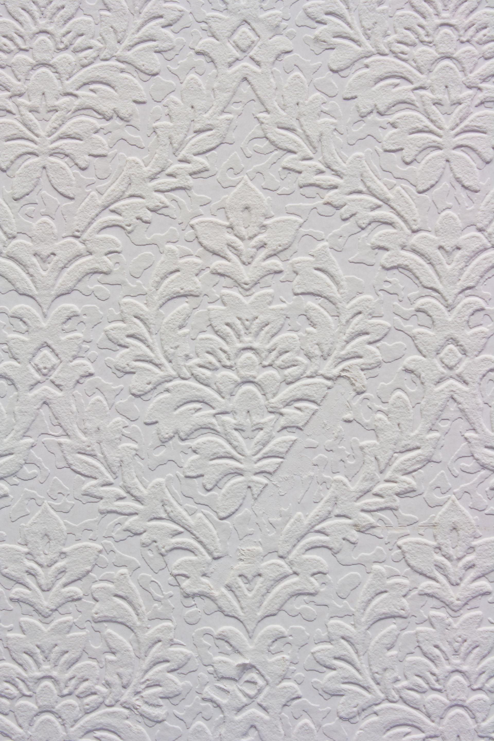 a close up of a white wall with a pattern on it .