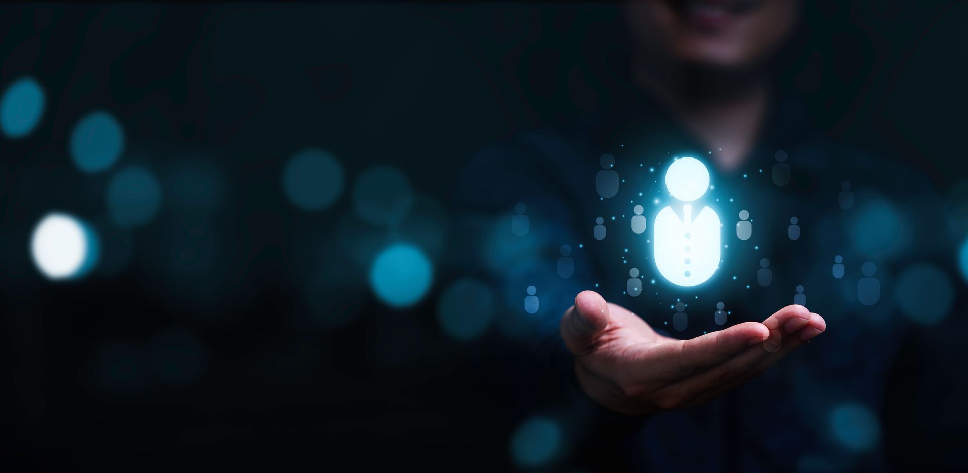 Person holding a glowing human figure hologram; concept of human resources or networking.