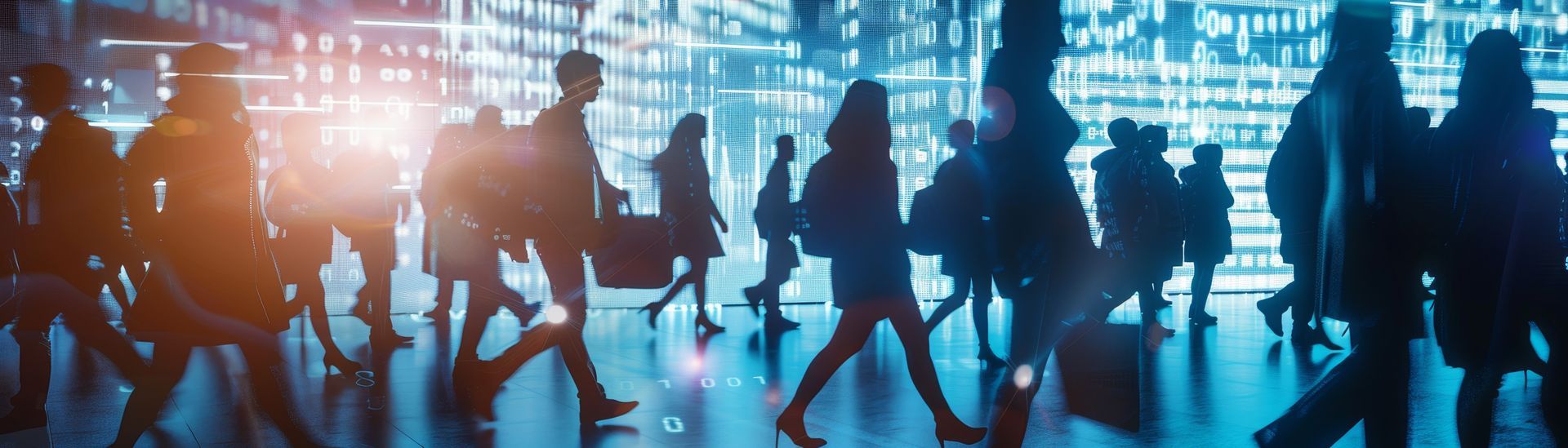 A group of people are walking down a street at night.