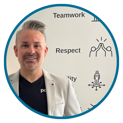 A man in a black suit and tie smiles, inside a teal circle.