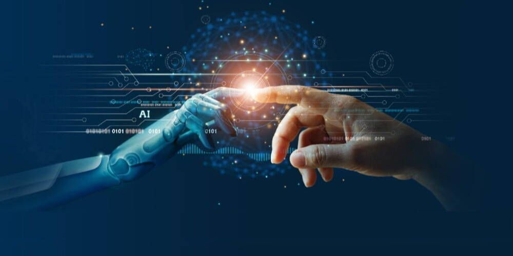 A man and a robot are touching each other 's hands.