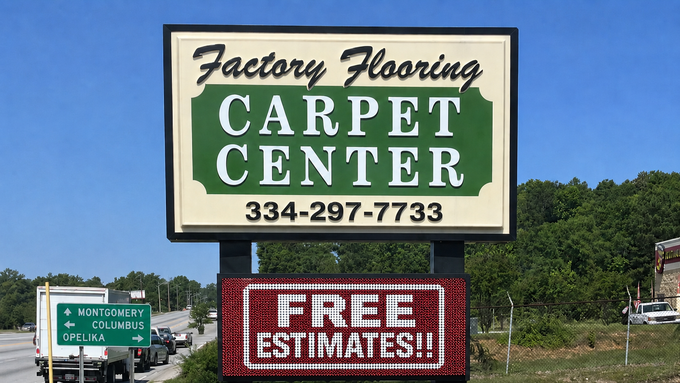 Carpet Center roadside sign with phone number and “Free Estimates,” against a blue sky.