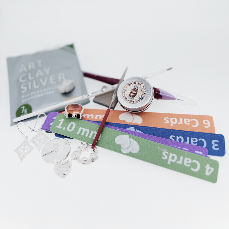 A book called art clay silver is laying on a table