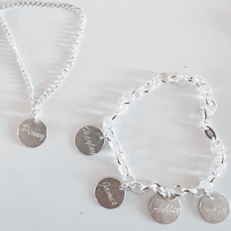 A necklace and a bracelet with names engraved on them