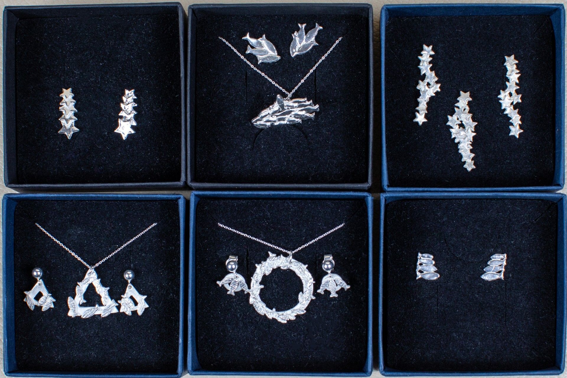 Six boxes of silver jewelry including necklaces and earrings