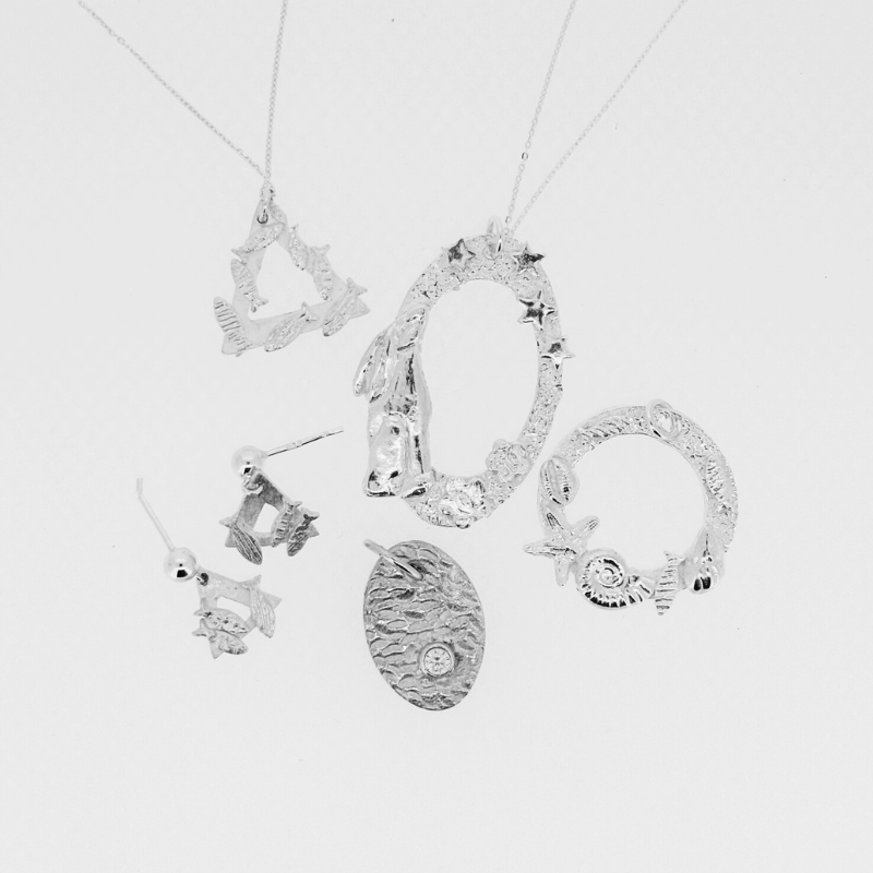 A collection of silver jewellry including a necklace and earrings