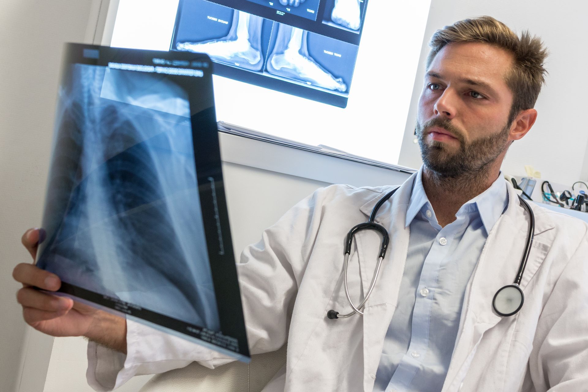 A doctor is holding an x-ray of a person 's lungs.