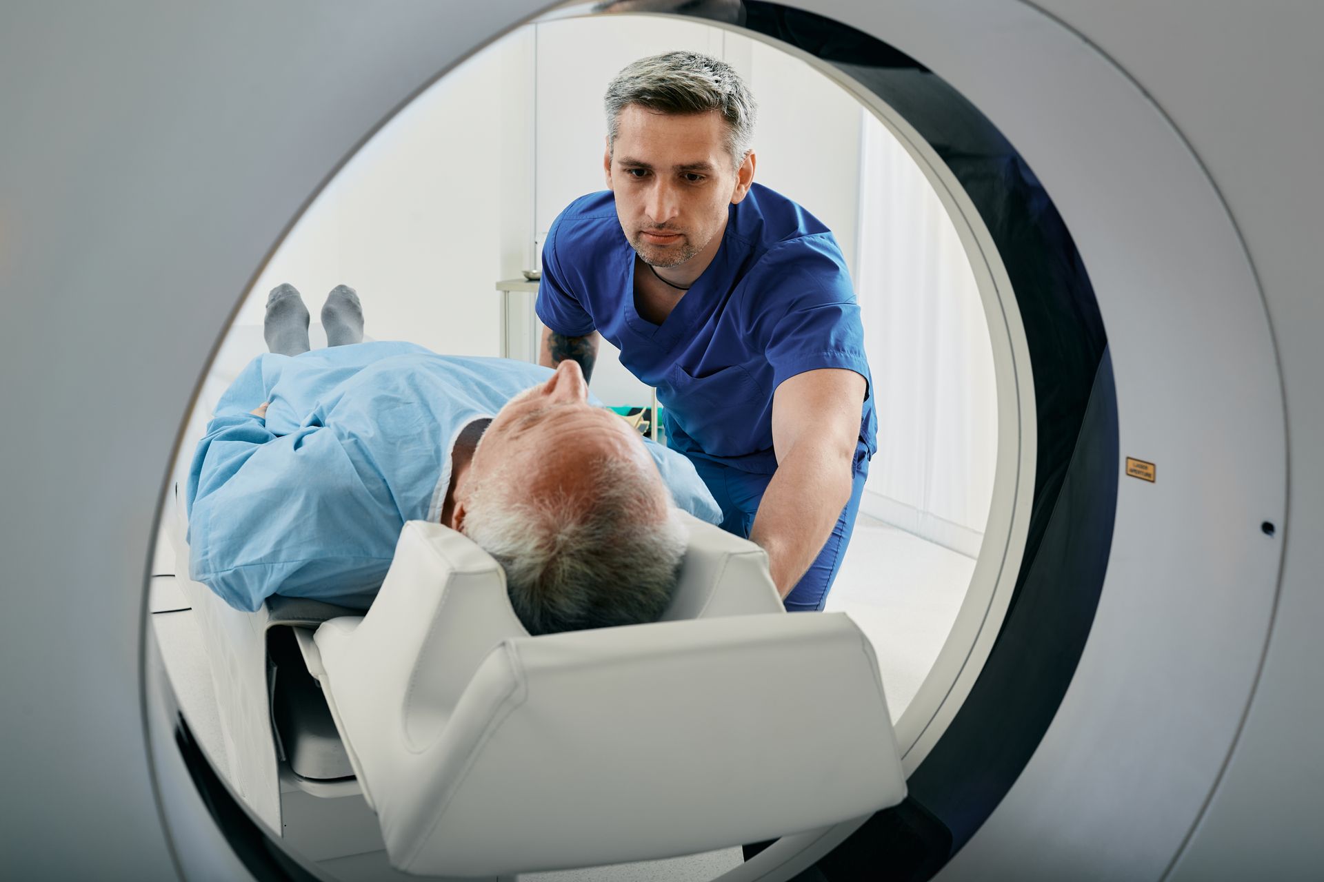 A man is getting a ct scan in a hospital.