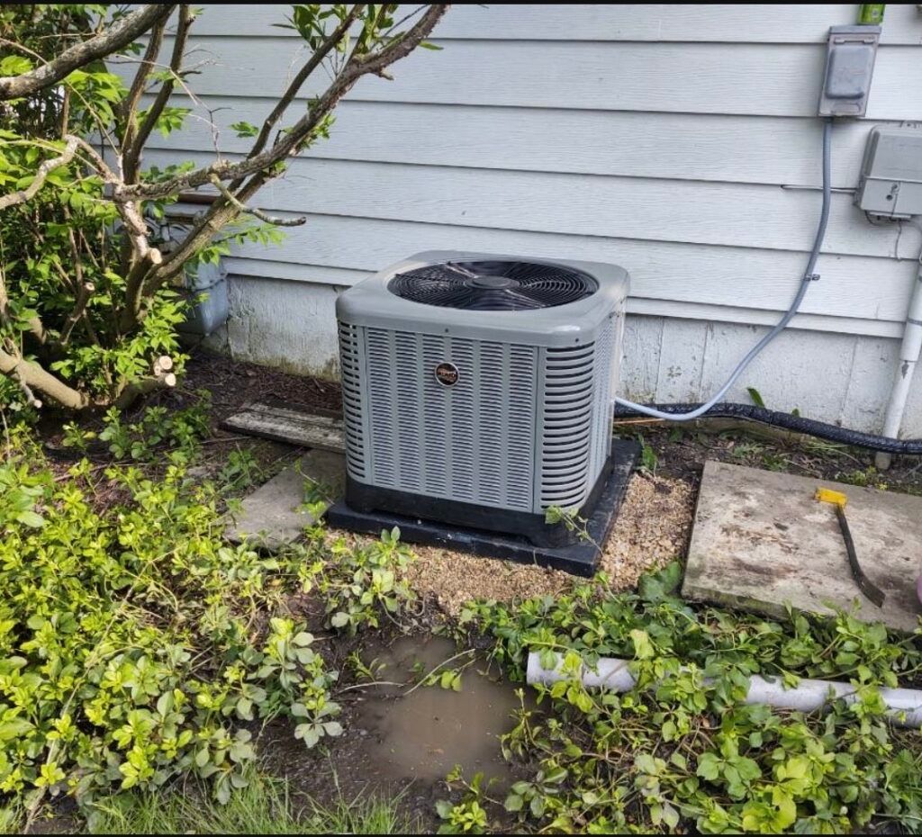 An air conditioner is sitting on the side of a house