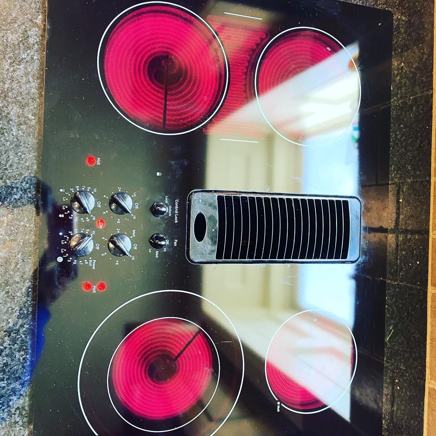 A close up of a stove top oven with red burners