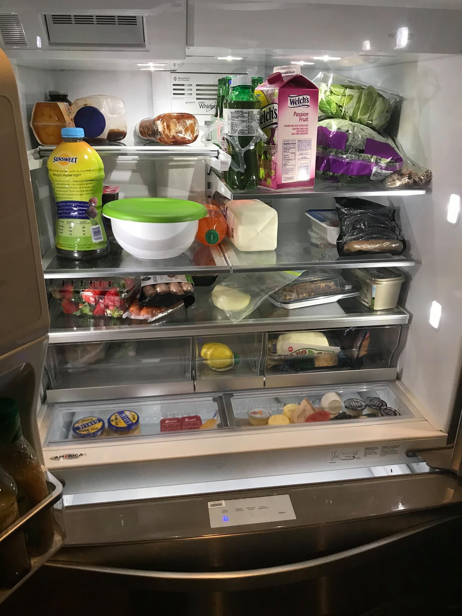 A refrigerator filled with lots of food and drinks.