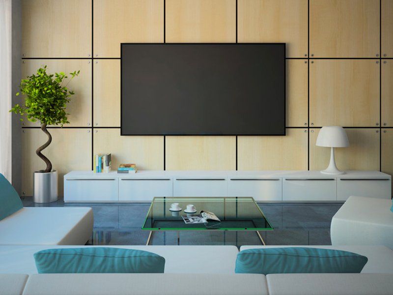 a wall mounted television in the living room