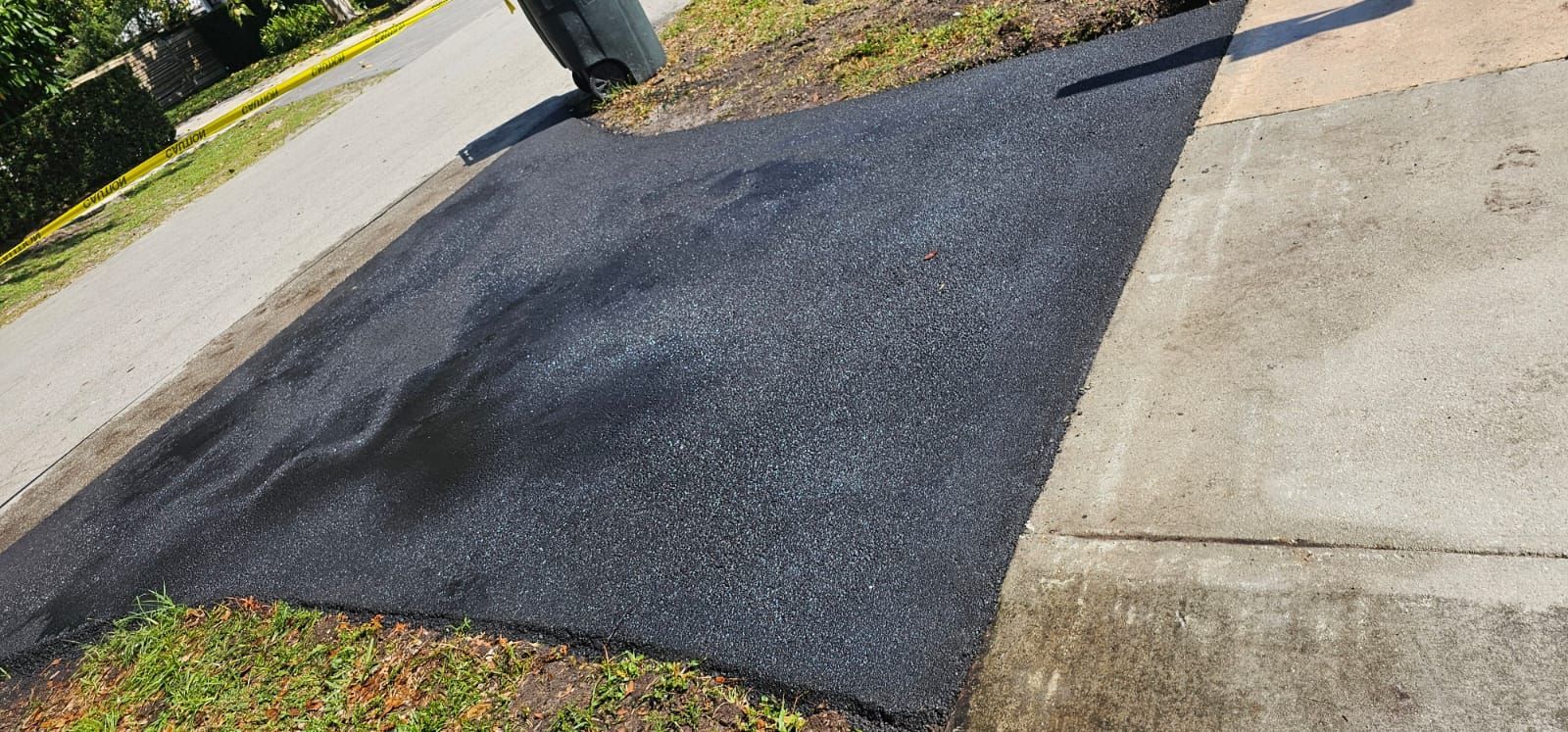 A worker diligently installing pavers on a pathway, carefully arranging each piece with precision and expertise.