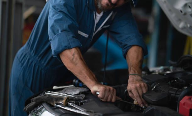 Experienced auto repair technician servicing a vehicle.