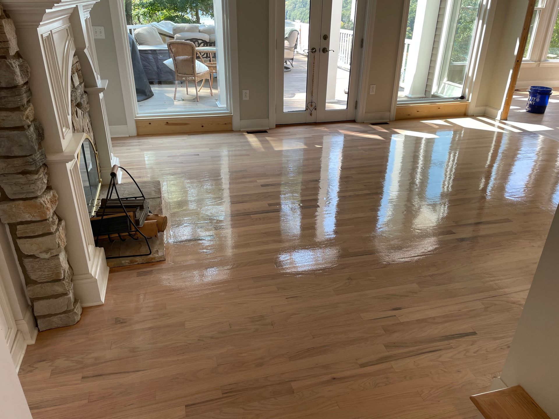A living room with hardwood floors and a fireplace.