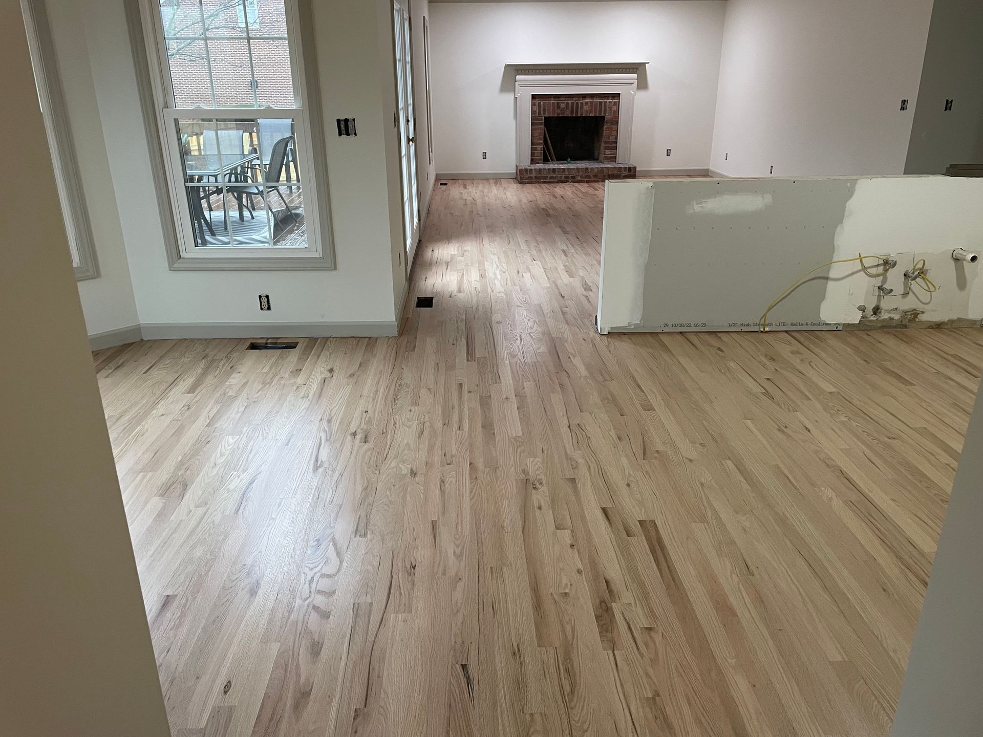 A living room with hardwood floors and a fireplace.