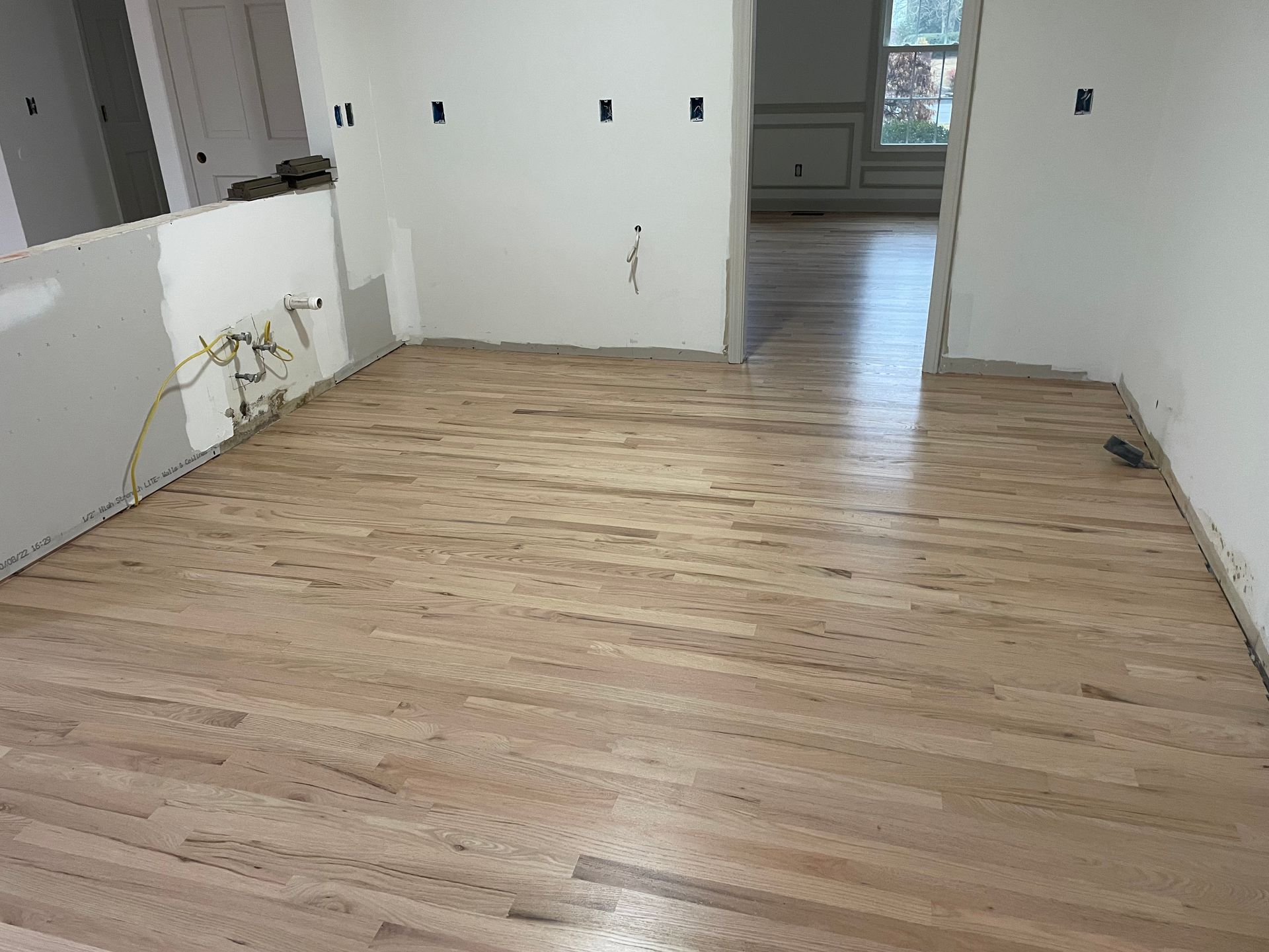 A room with hardwood floors and white walls.