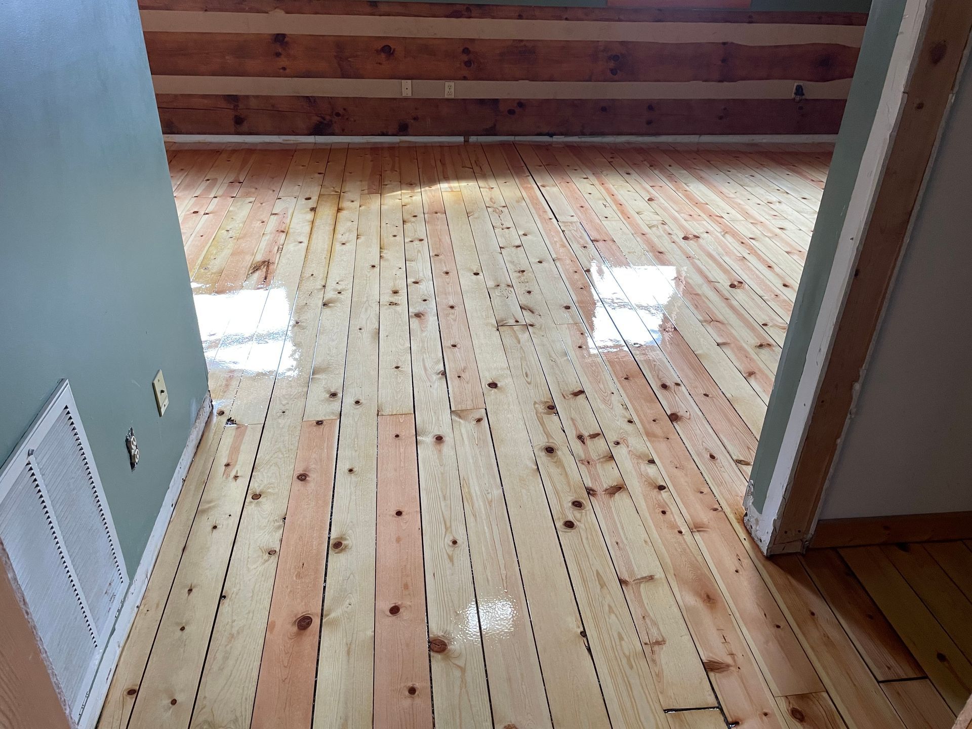 A wooden floor in a room with a window