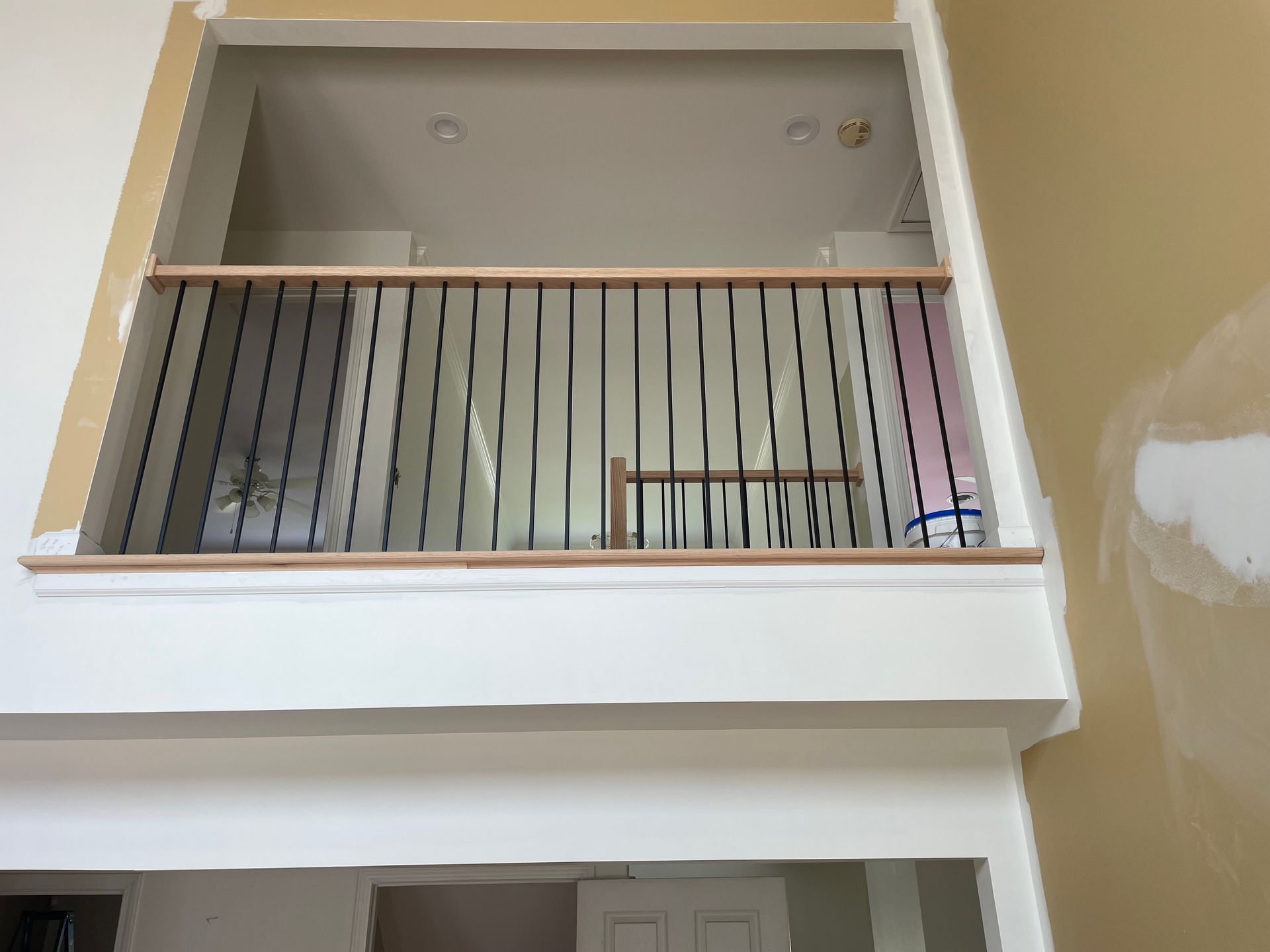 A balcony with a railing in a house under construction.