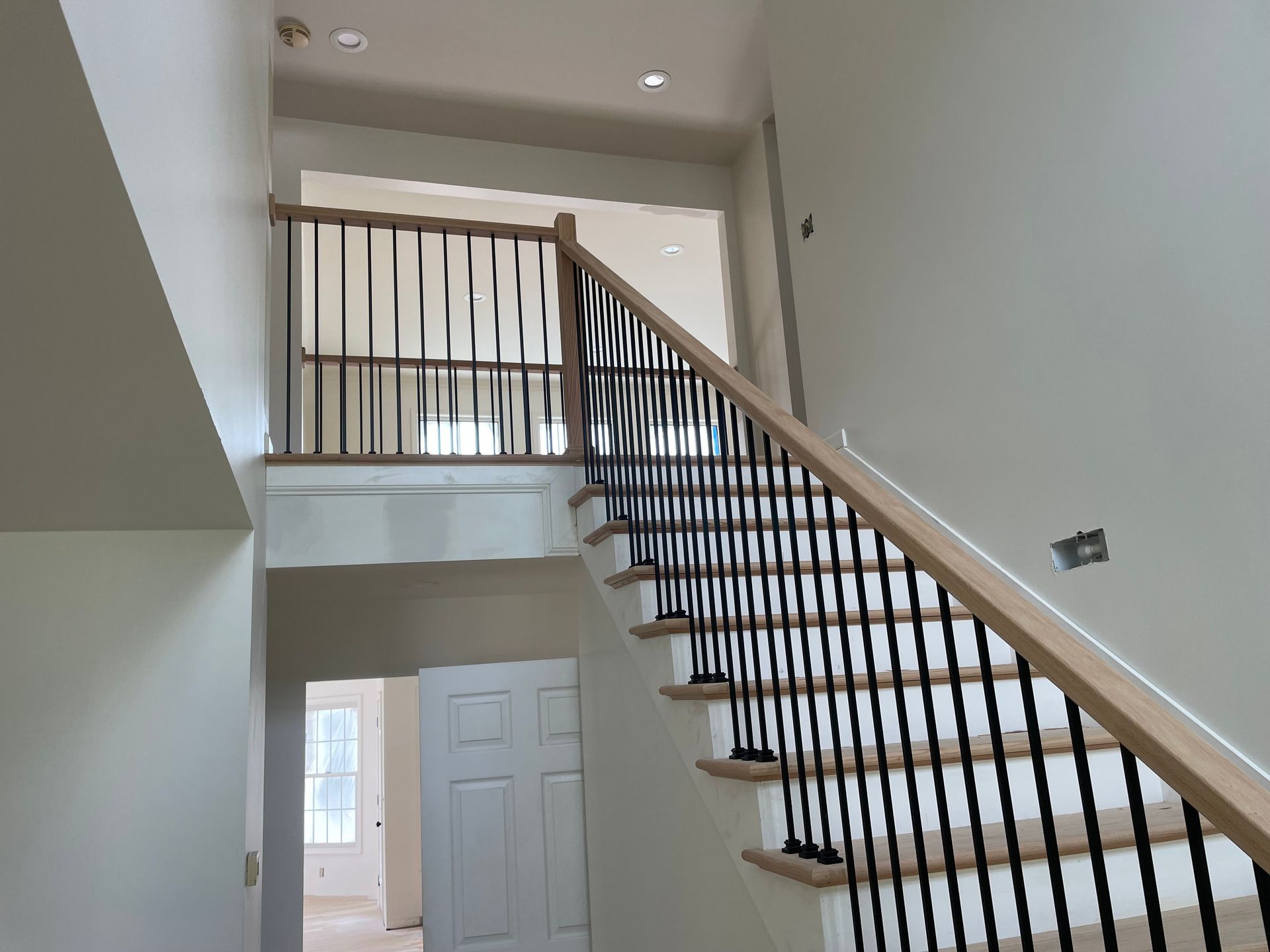 A staircase in a house with a wooden railing