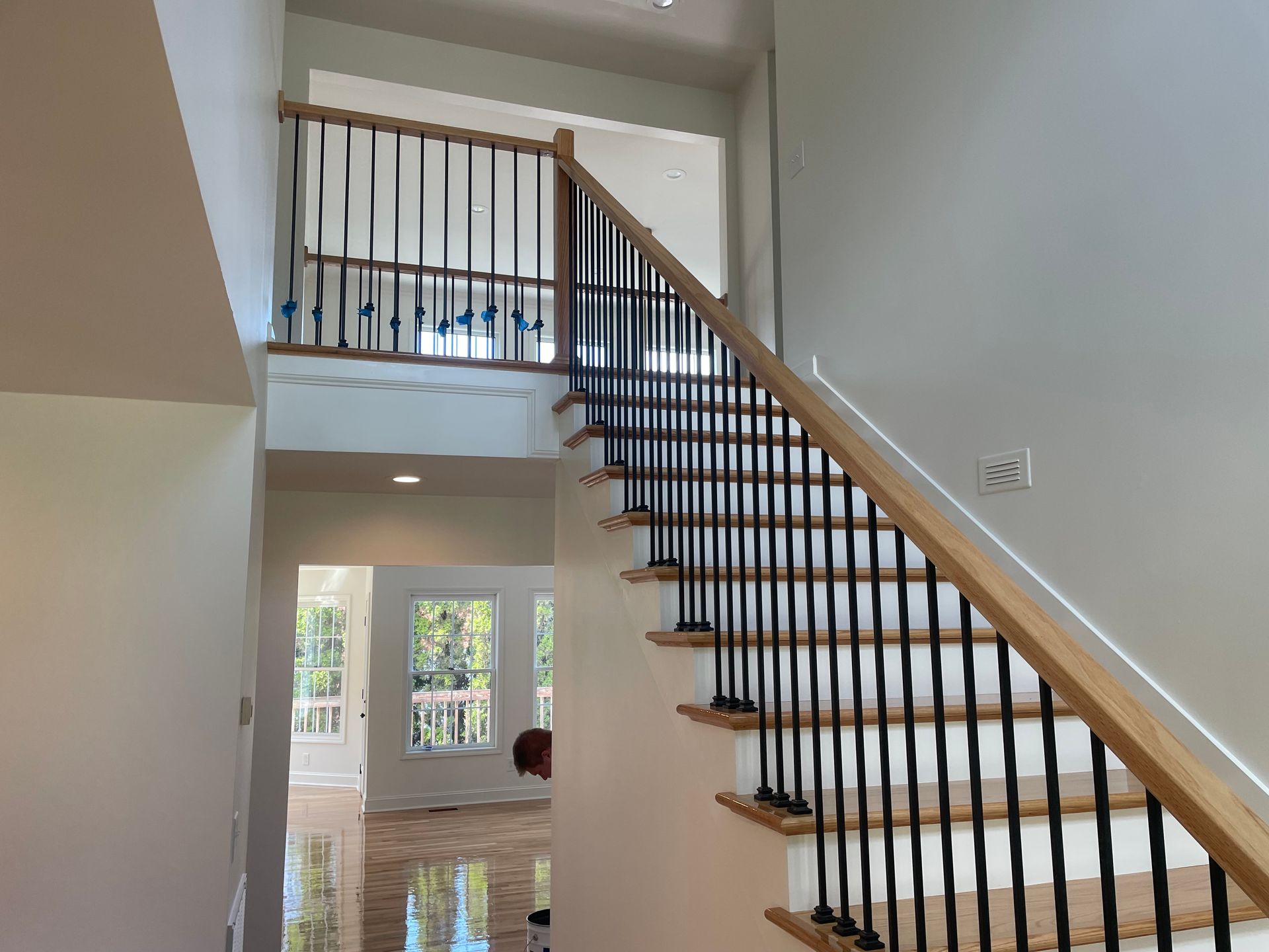 A staircase in a house with a wooden railing