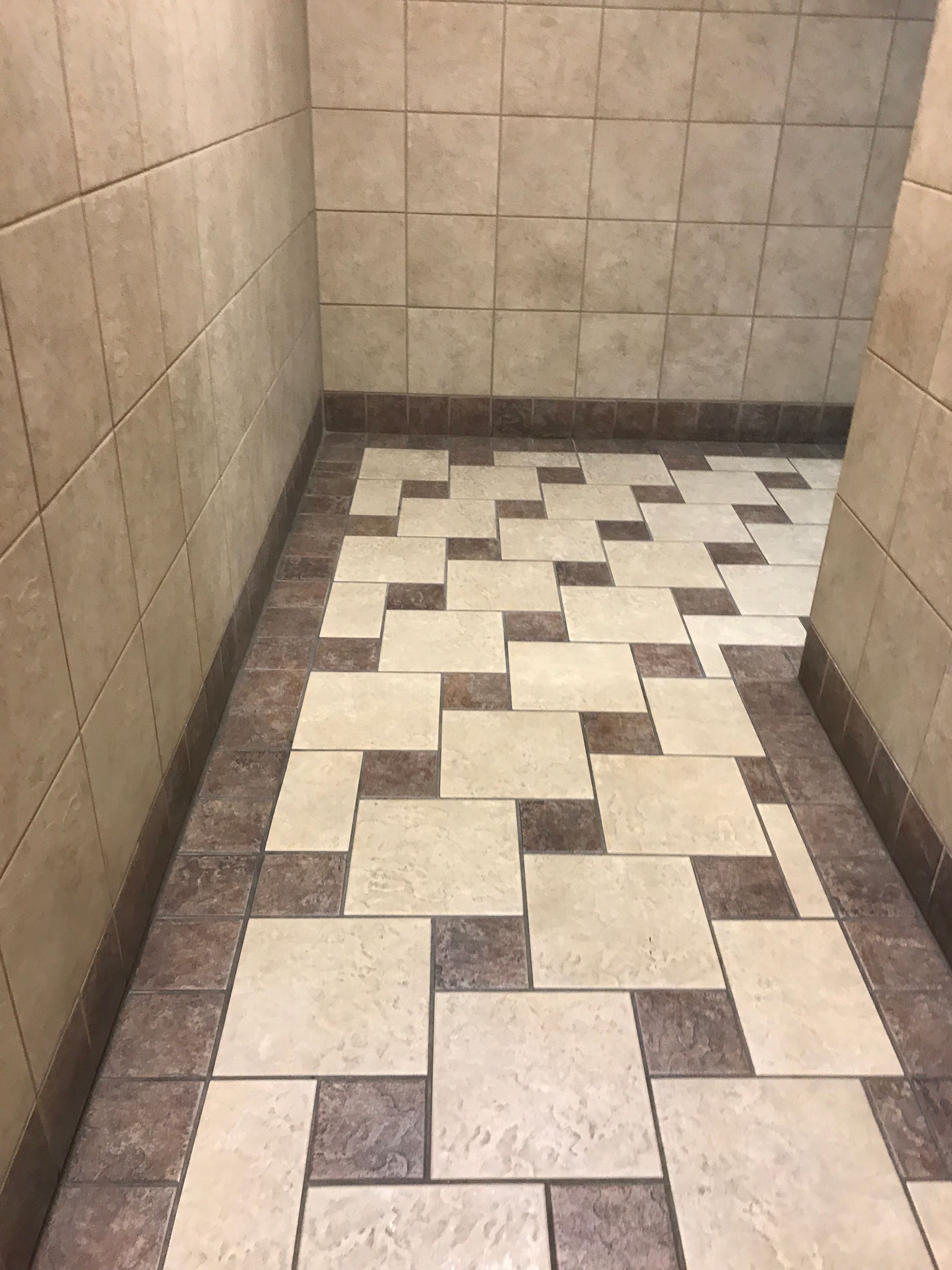 A hallway with tiles on the floor and walls