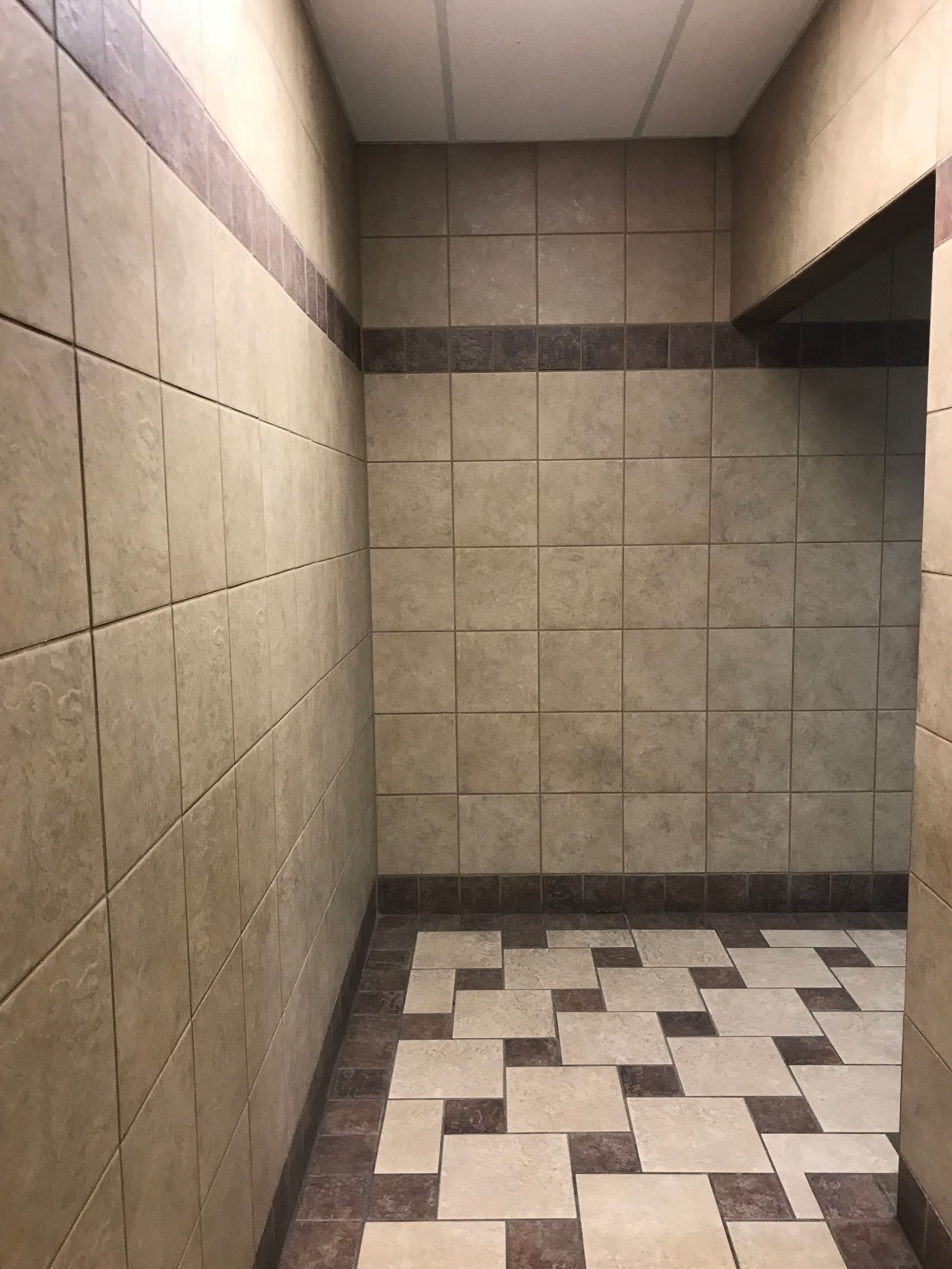 A hallway with tiled walls and a tiled floor.