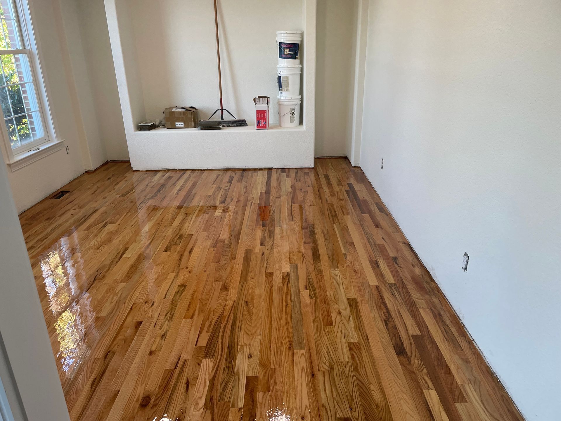 A room with a wooden floor and white walls.