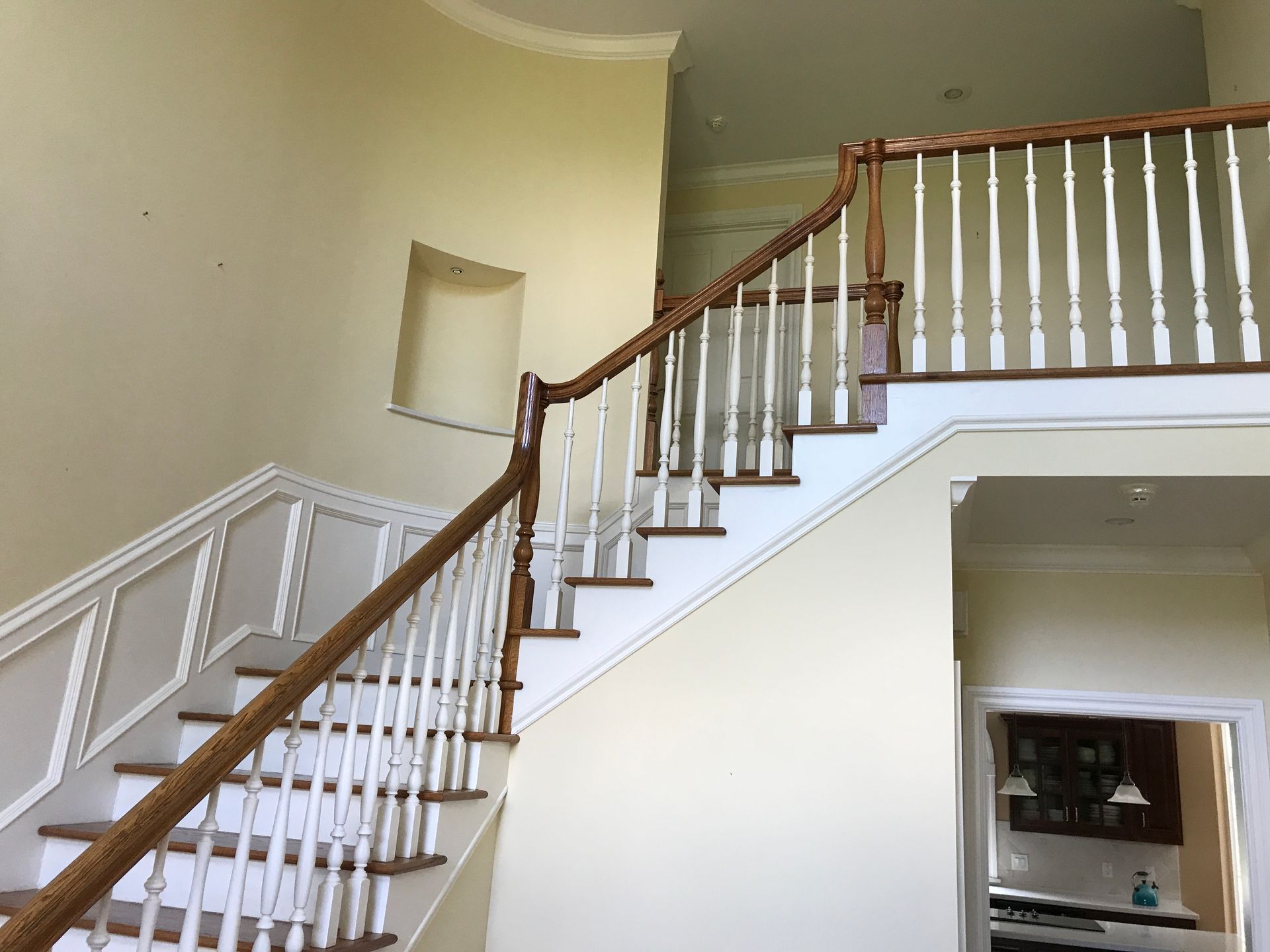A staircase with a wooden railing in a house