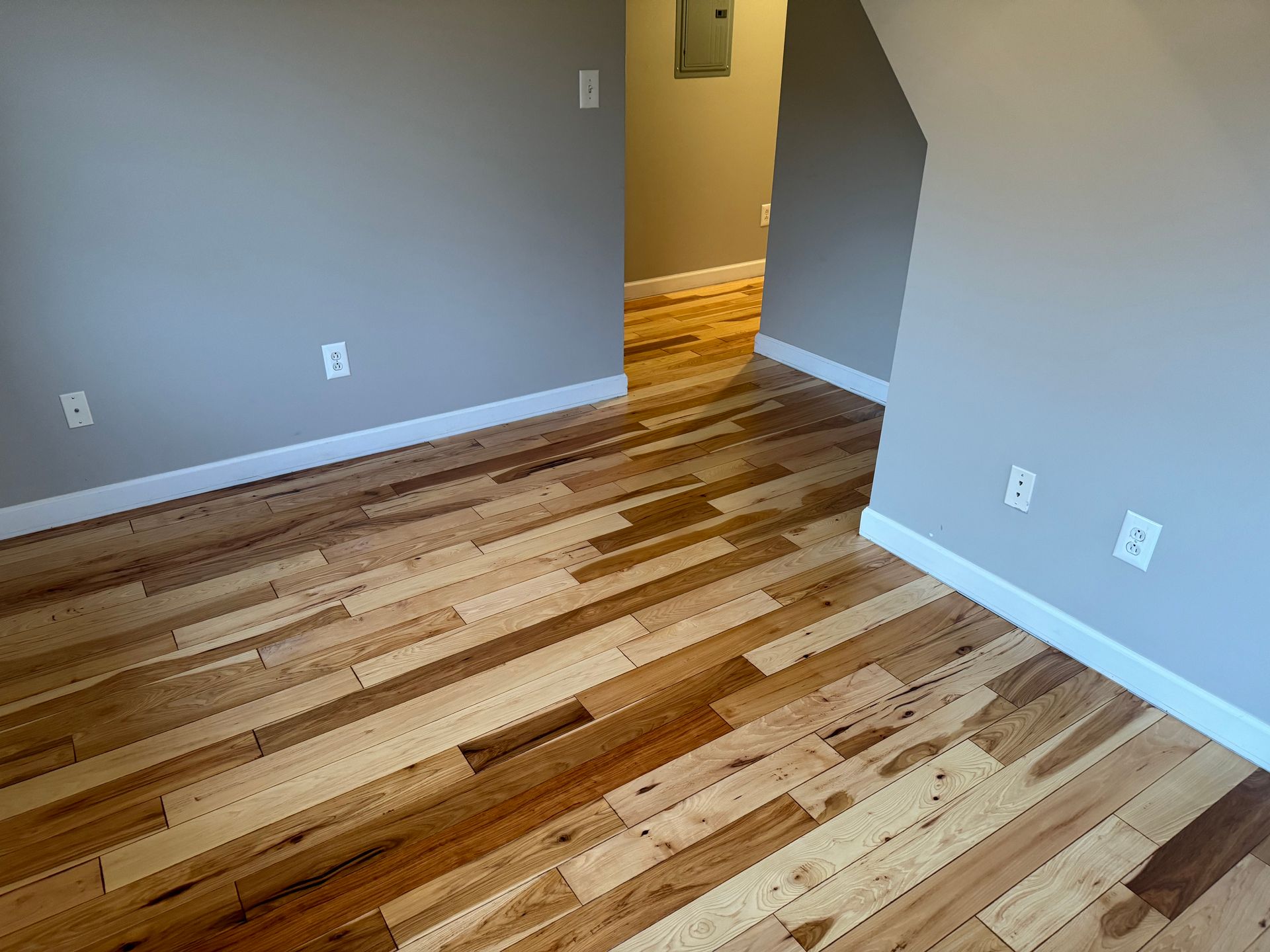 A room with hardwood floors and gray walls.