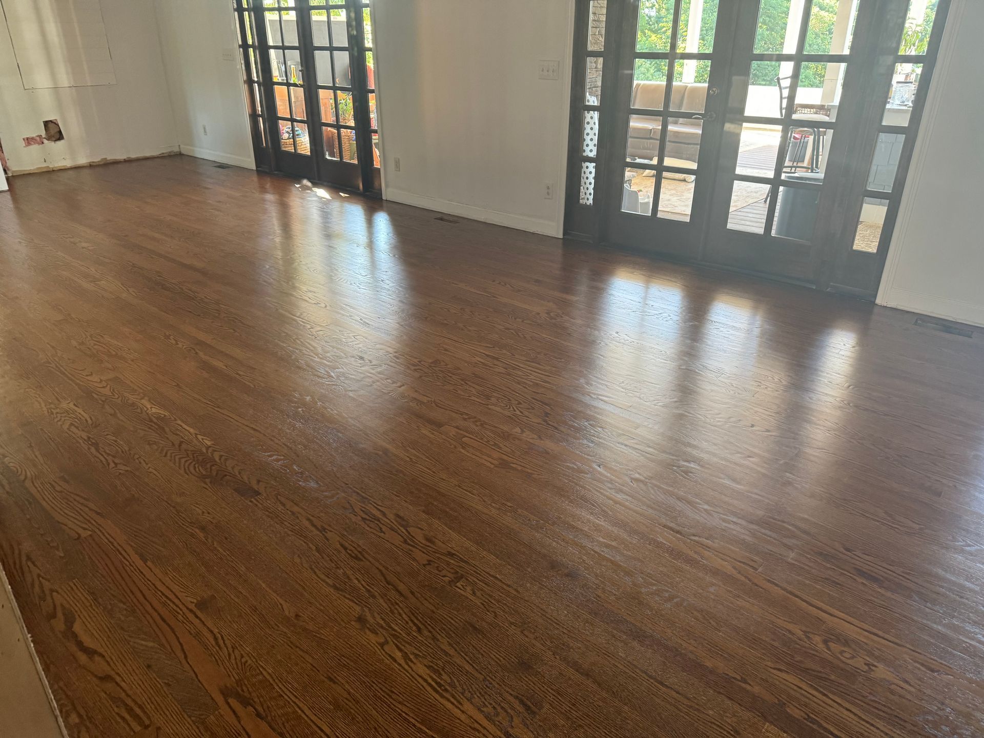 A living room with hardwood floors and french doors.