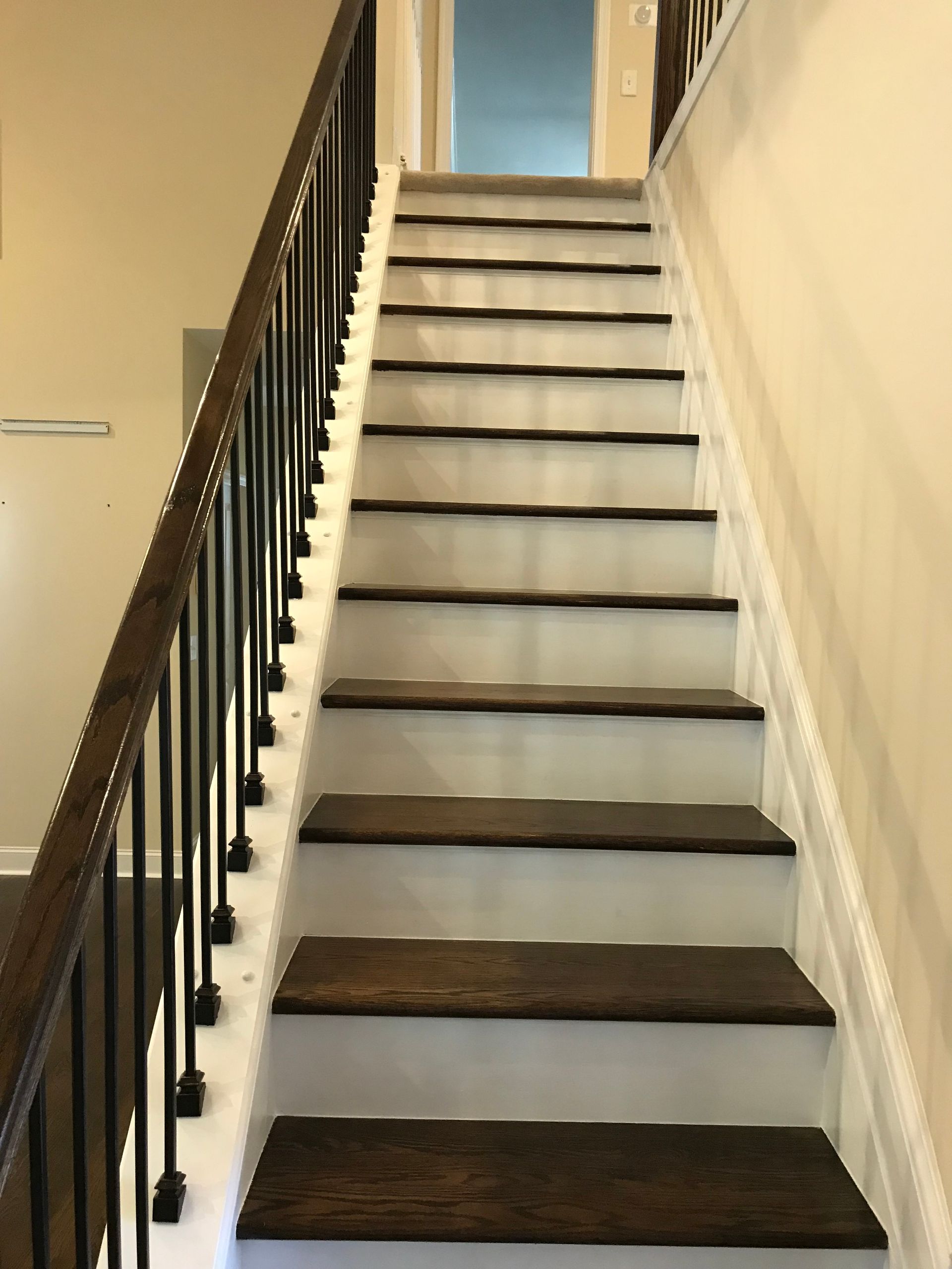 A staircase with wooden steps and a metal railing