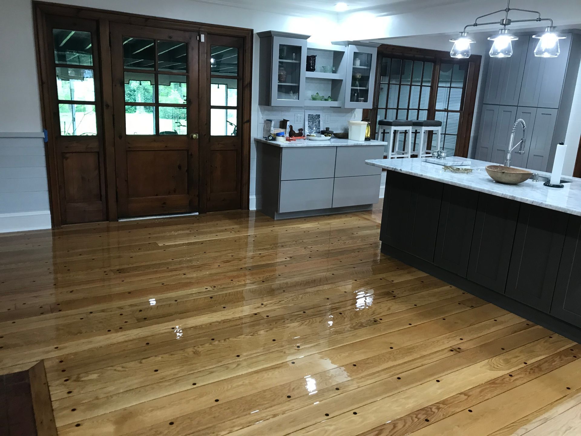 A kitchen with wooden floors and a large island