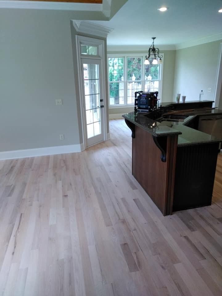 A kitchen with hardwood floors and a large island