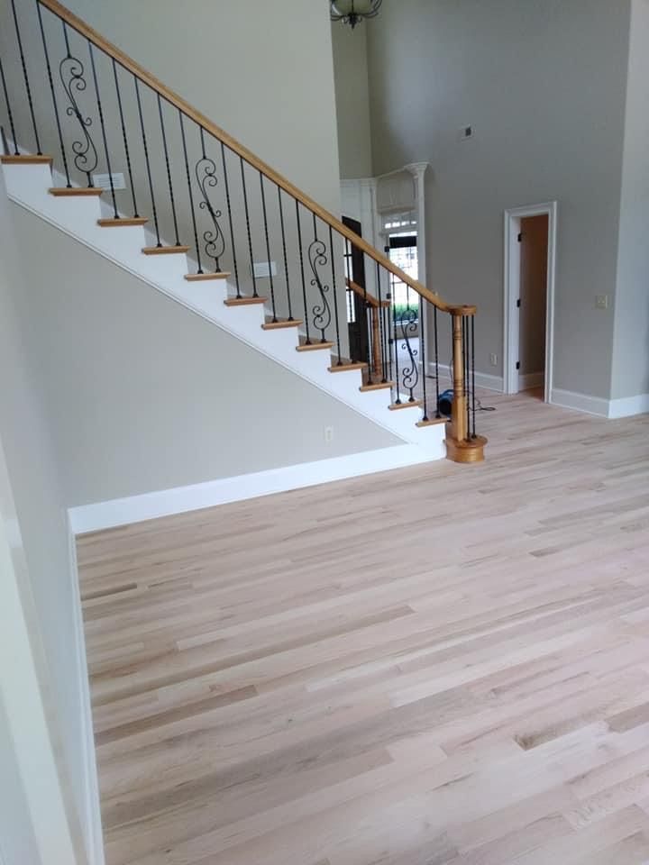 A wooden staircase with a metal railing in a house