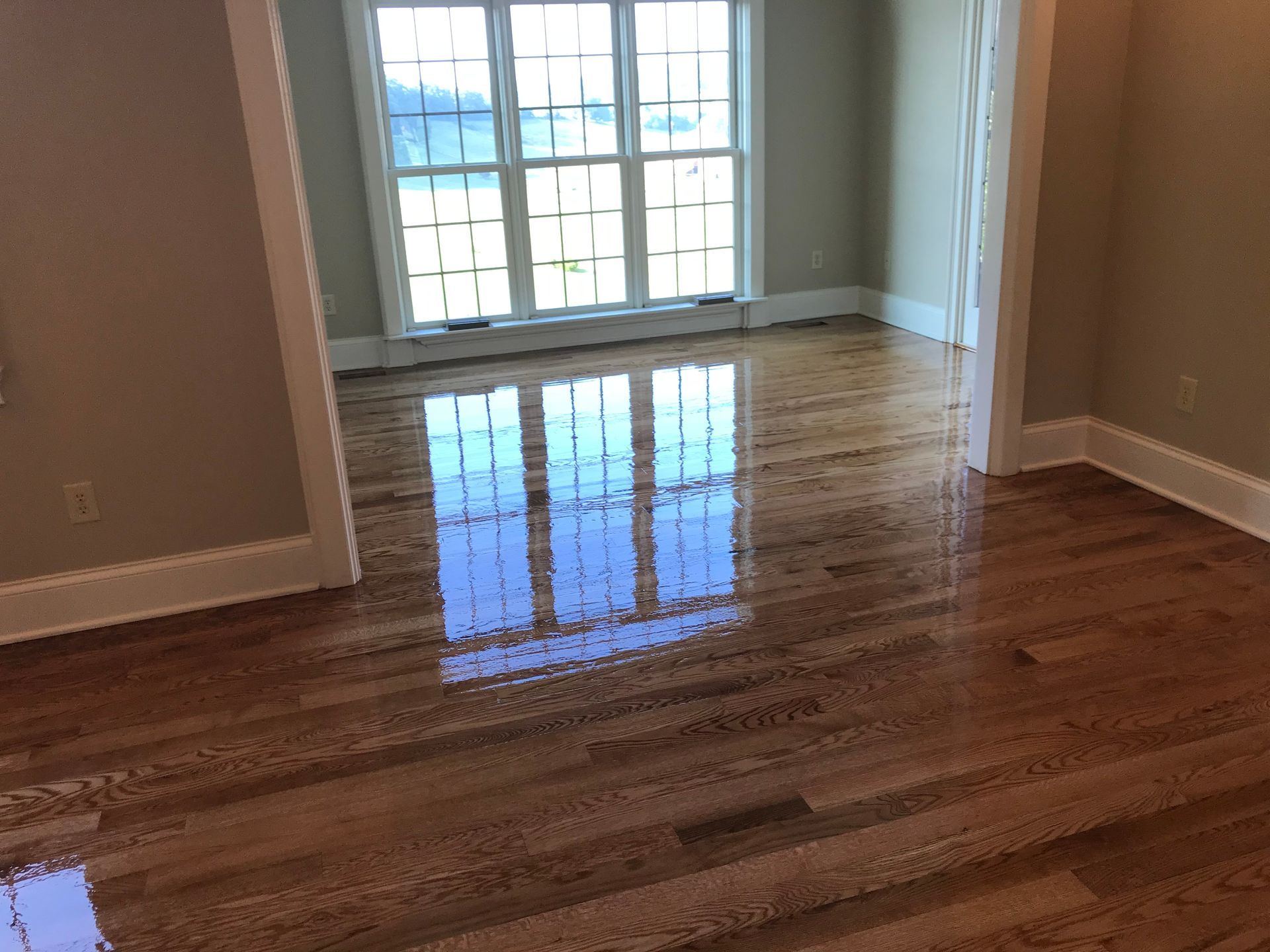 A room with hardwood floors and a window.