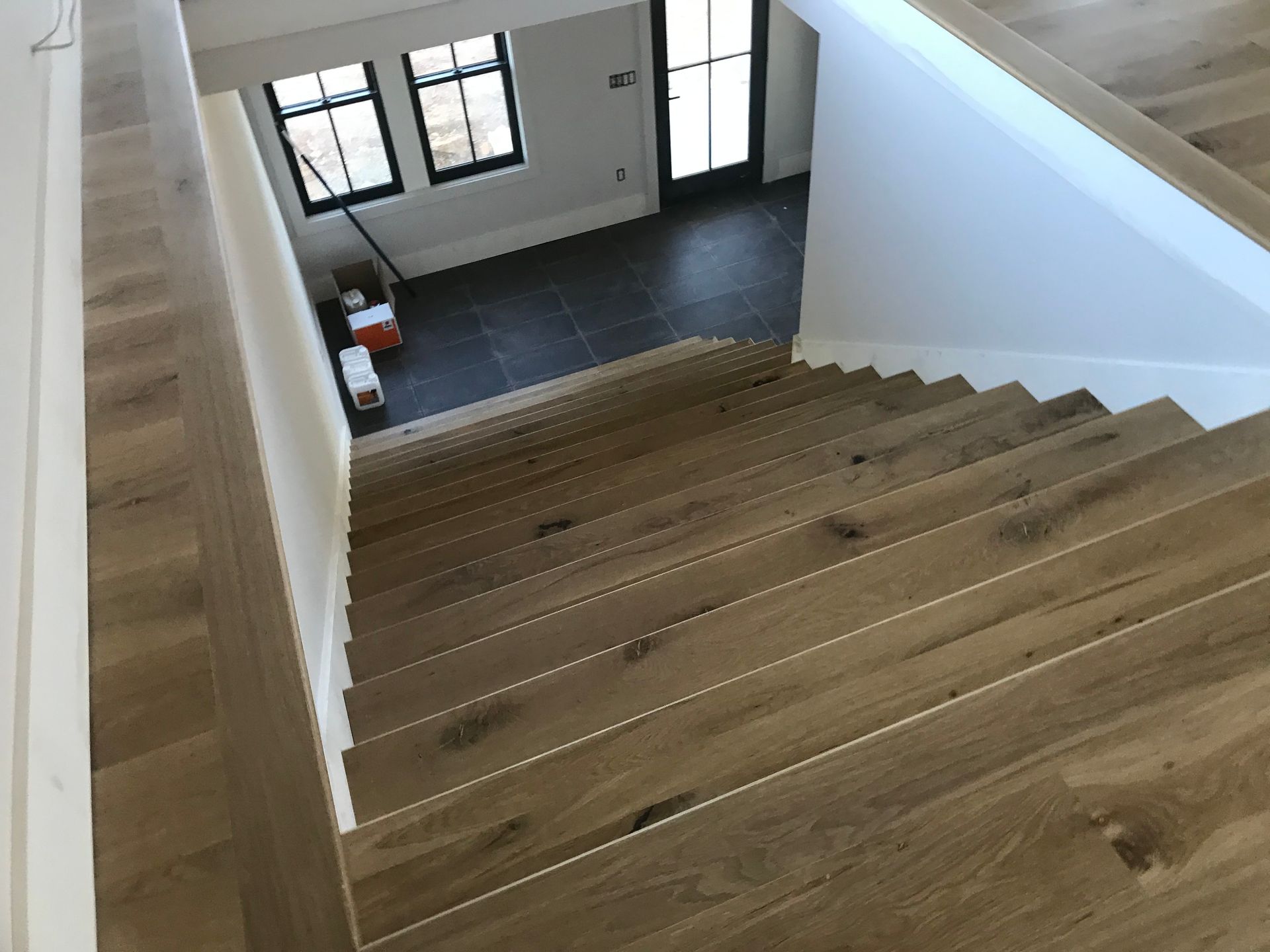 A wooden staircase leading up to a living room in a house.