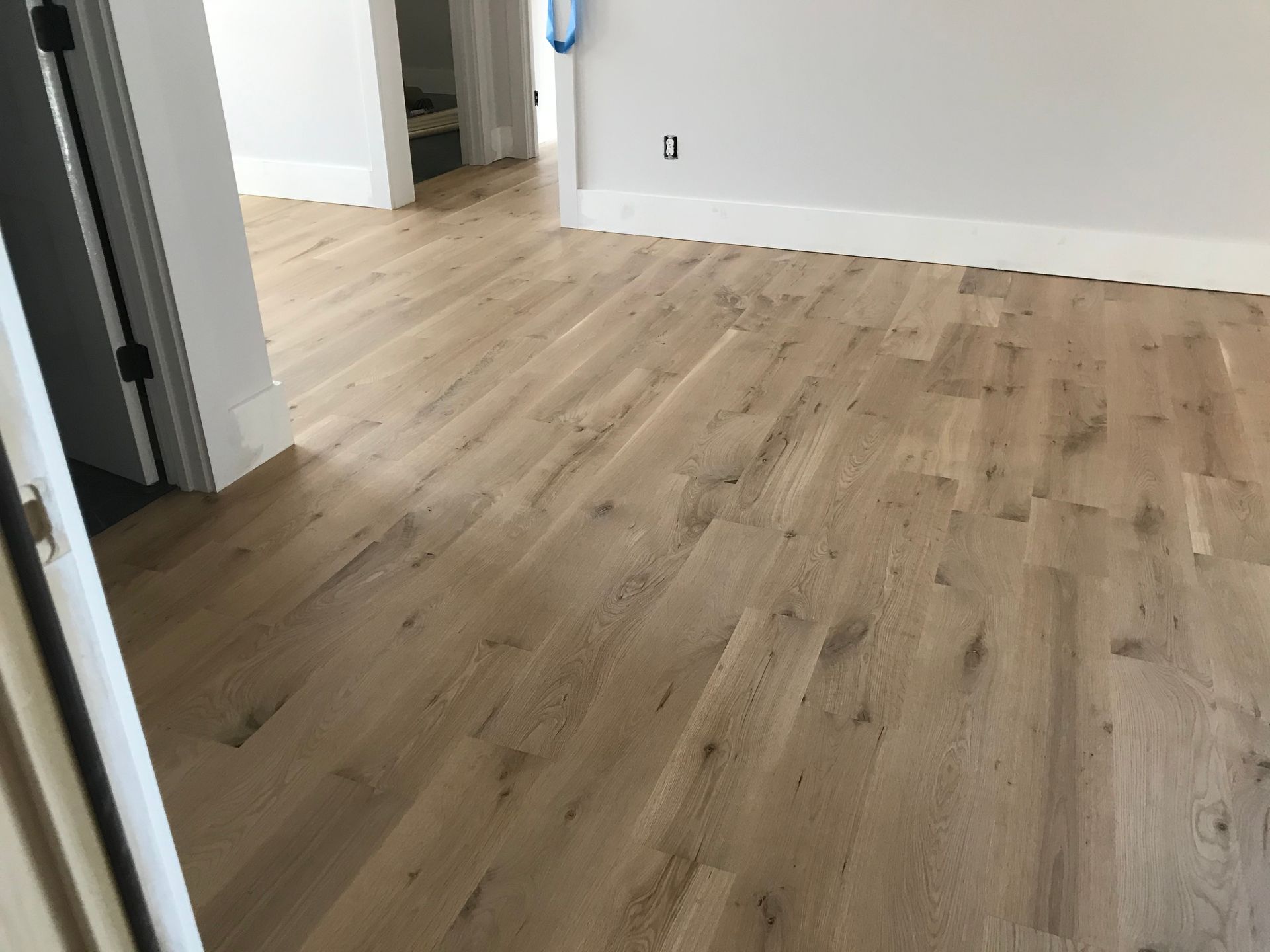 A room with hardwood floors and white walls.
