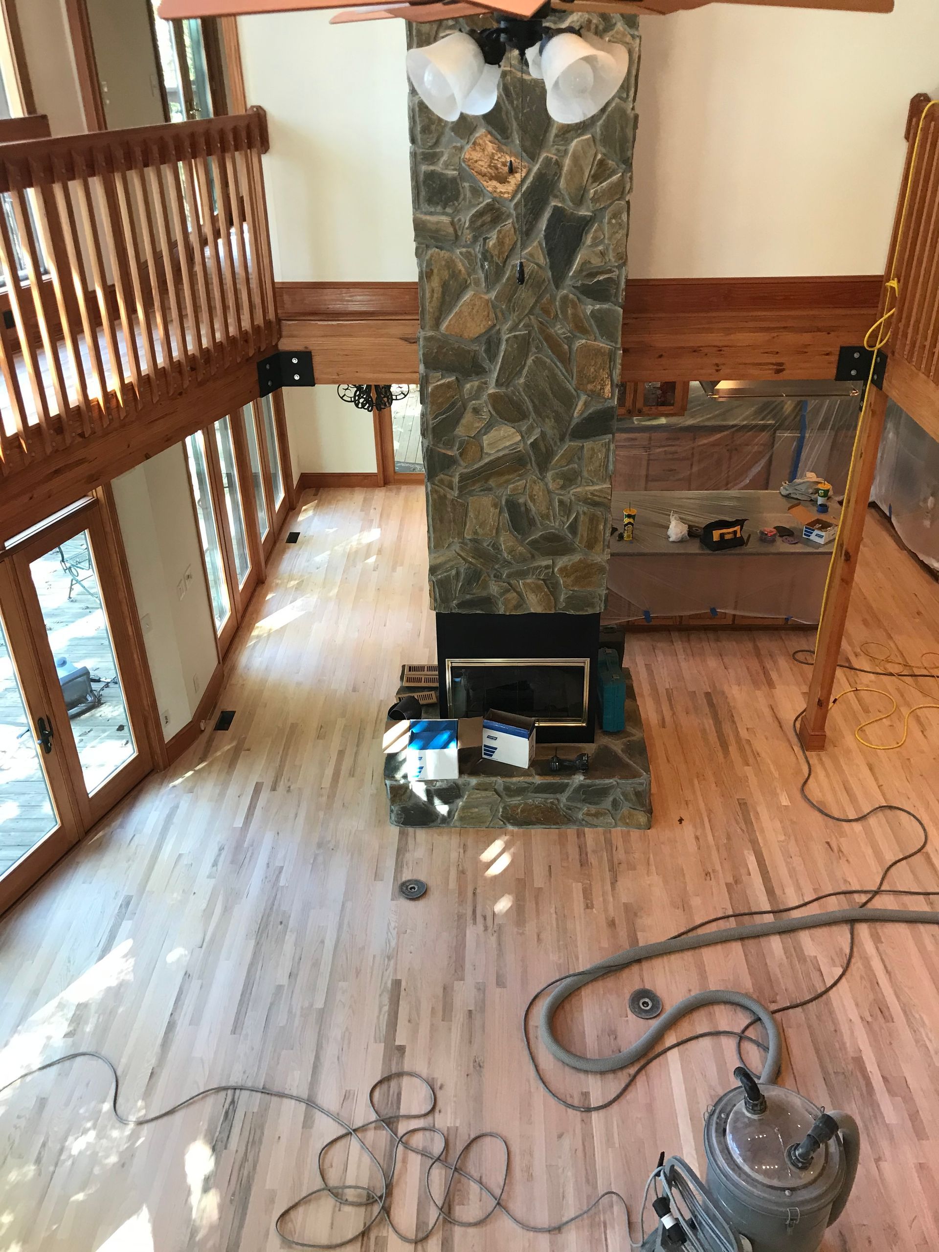 A vacuum cleaner is sitting in front of a fireplace in a living room.