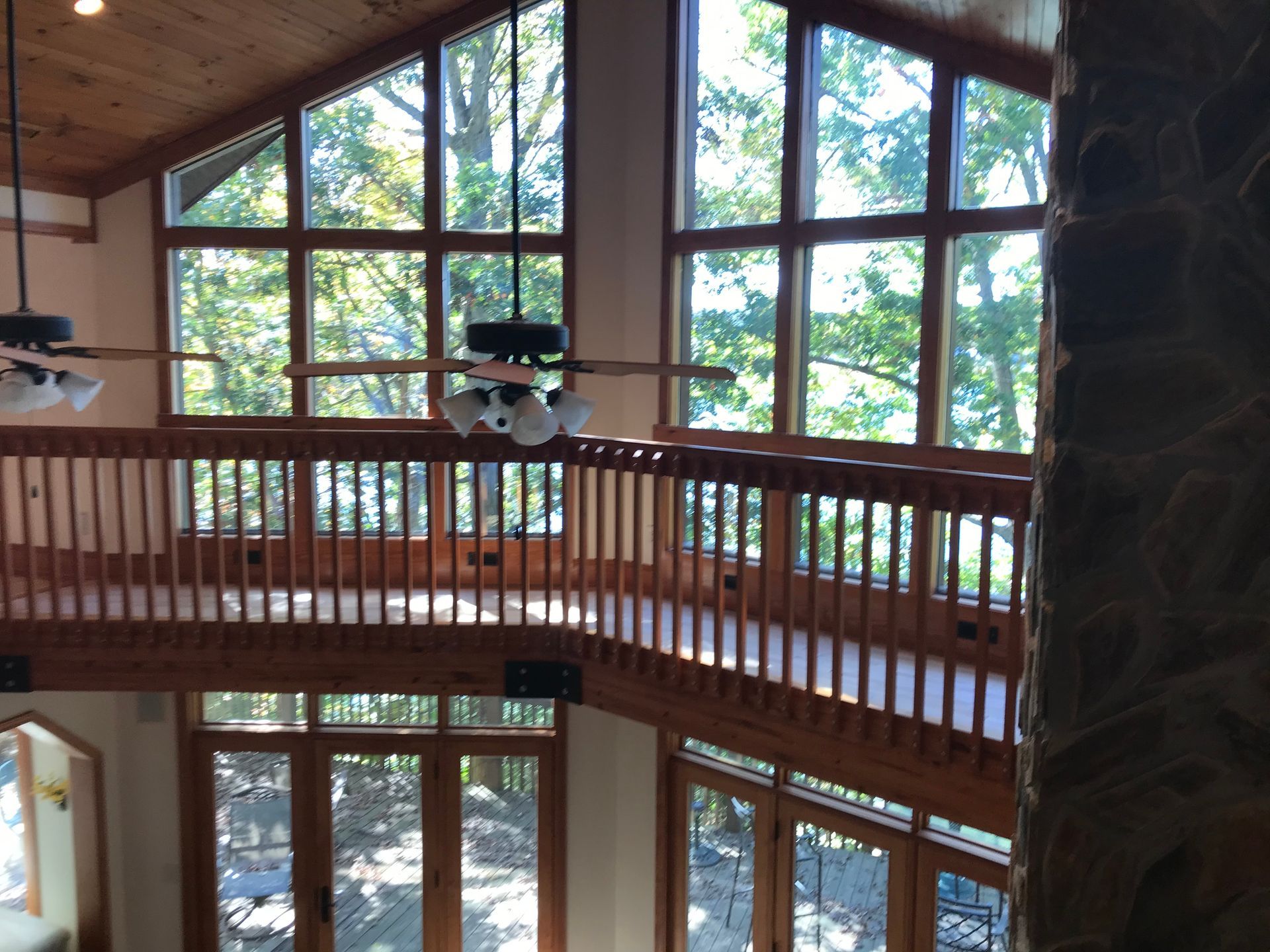 A room with a lot of windows and a ceiling fan