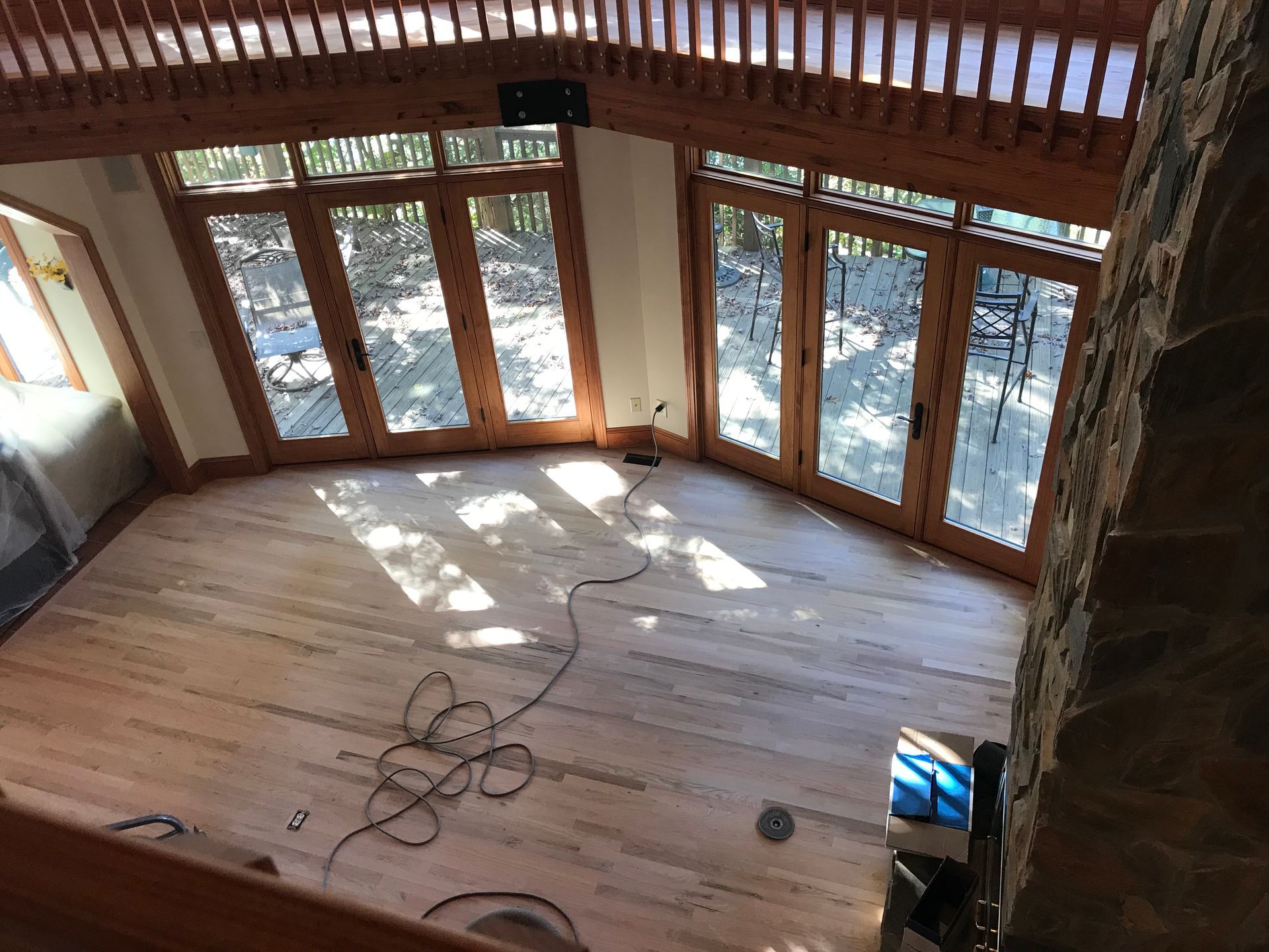 A room with a lot of windows and a wooden floor