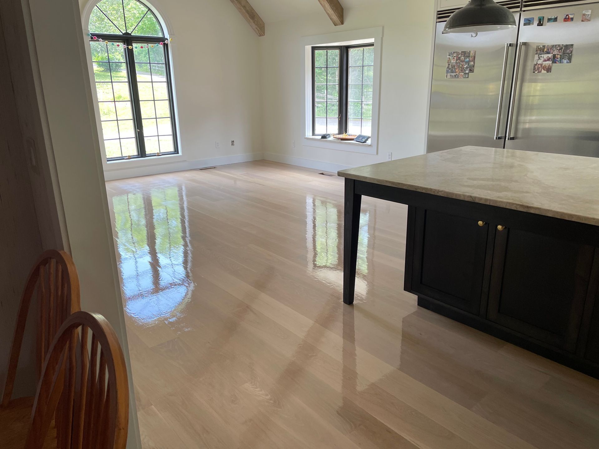 A kitchen with hardwood floors and a large island in the middle of the room.