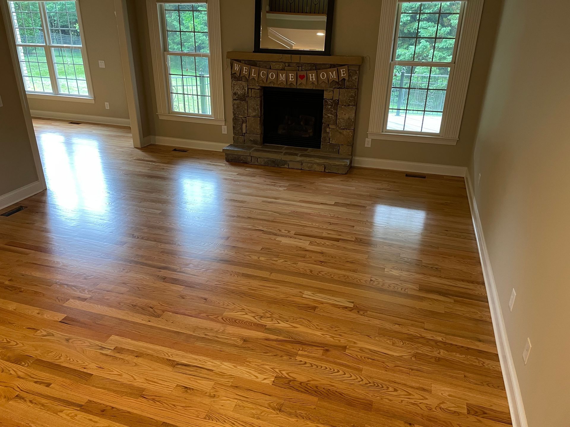 A living room with hardwood floors and a fireplace.