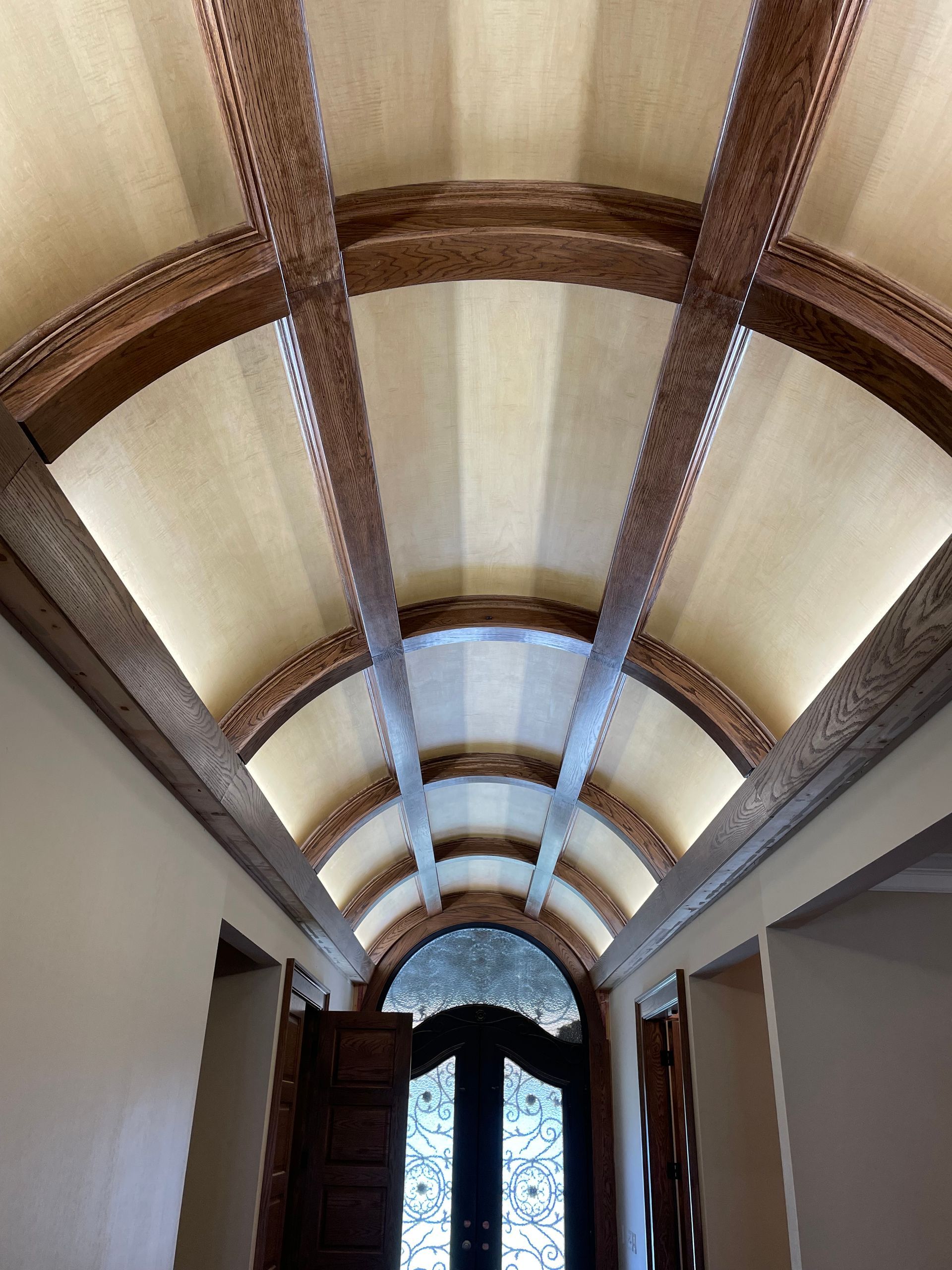 A hallway with arched ceilings and wooden beams